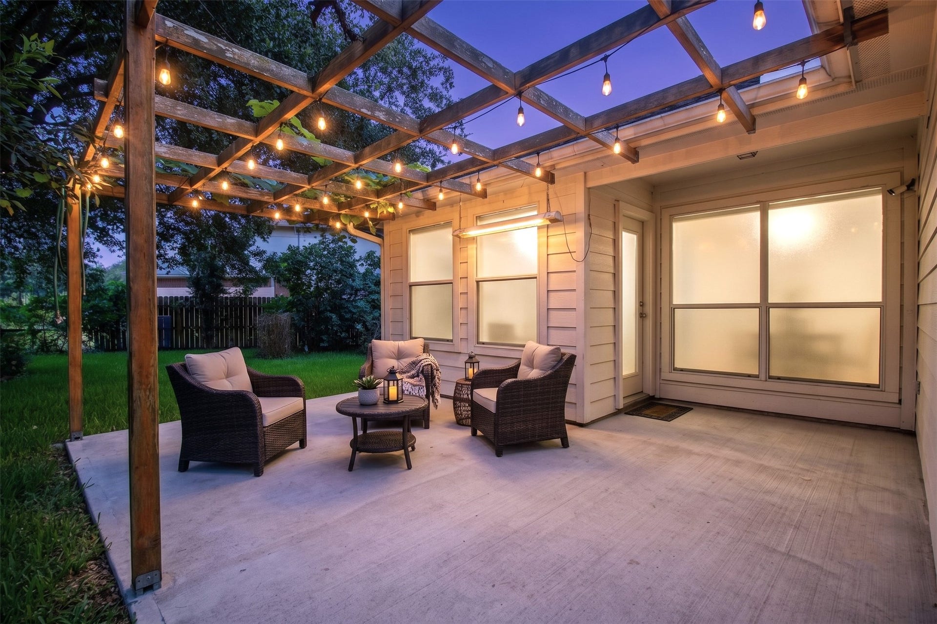 Amazing rear pergola with grape vines adorning the top. *Image was digitally altered to clean up the floor and add patio lights.