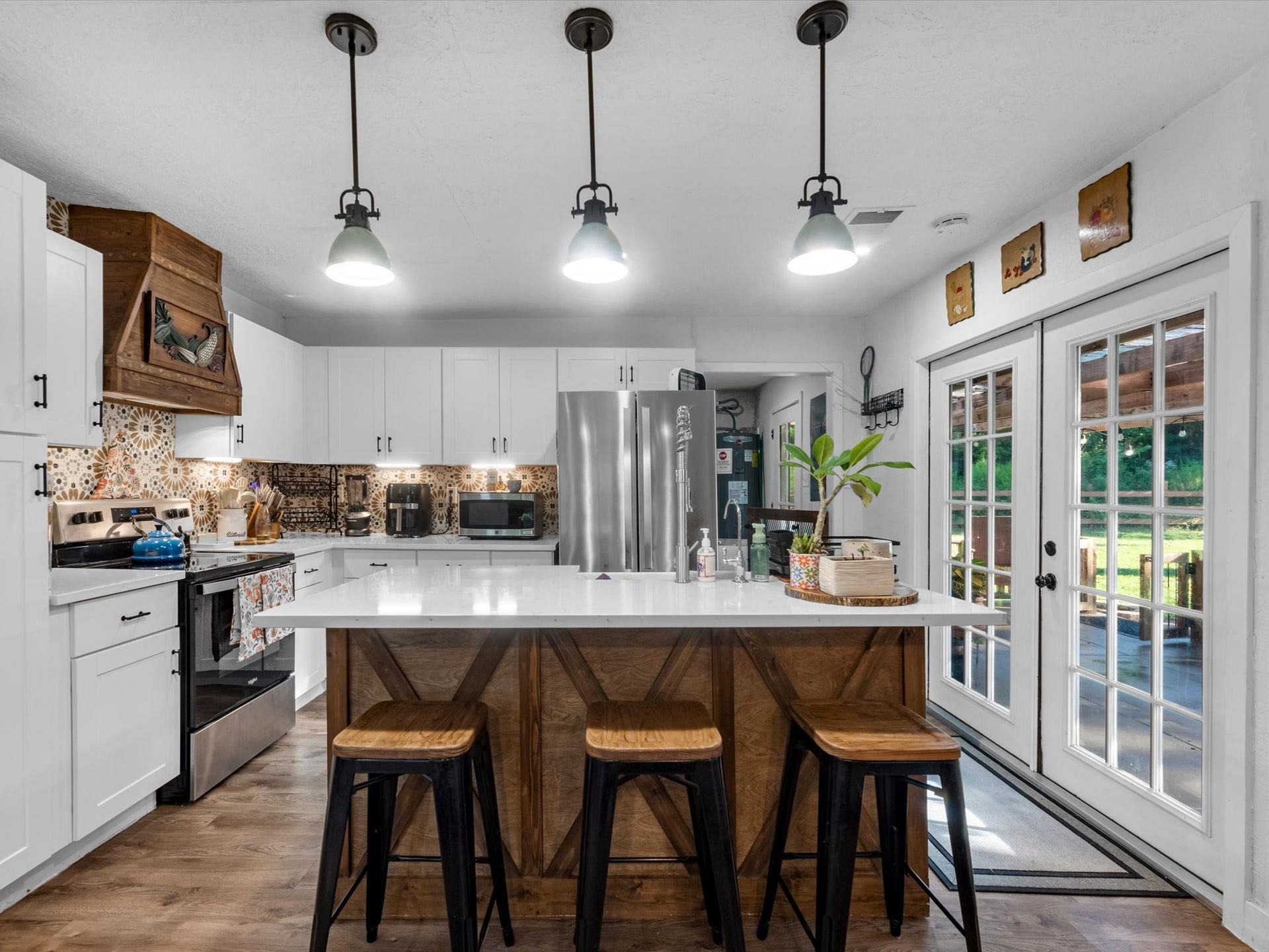 32403 Dobbin Huffsmith Road, Magnolia, TX 77354 Farmhouse-style kitchen featuring a classic farmhouse sink, spacious island, and a rustic-modern design that blends warmth with updated finishes.