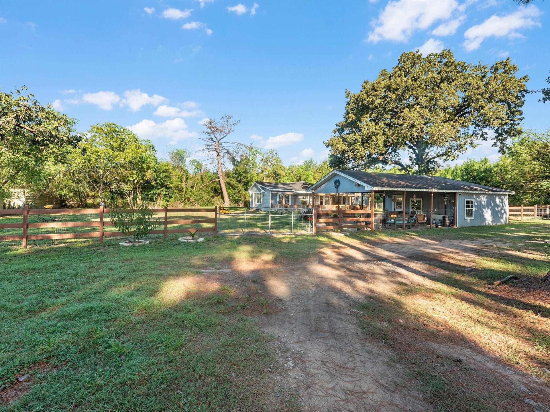 32403 Dobbin Huffsmith Road, Magnolia, TX 77354 Driveway leading up to properties homes are separated by a gate