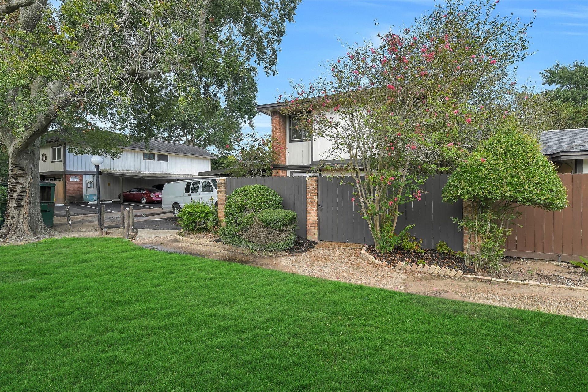 Beyond the gate, the home opens to its own enclosed courtyard and private entrance