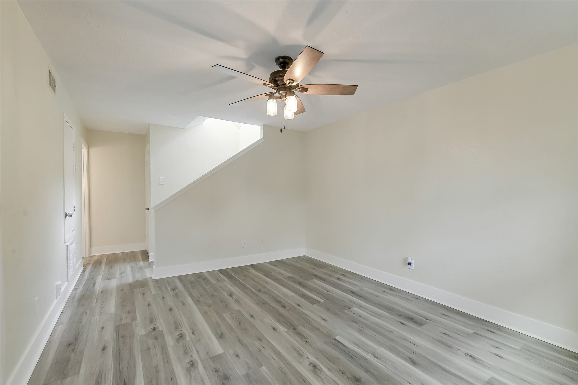 Fresh flooring and neutral finishes give the living room a clean canvas for your own style
