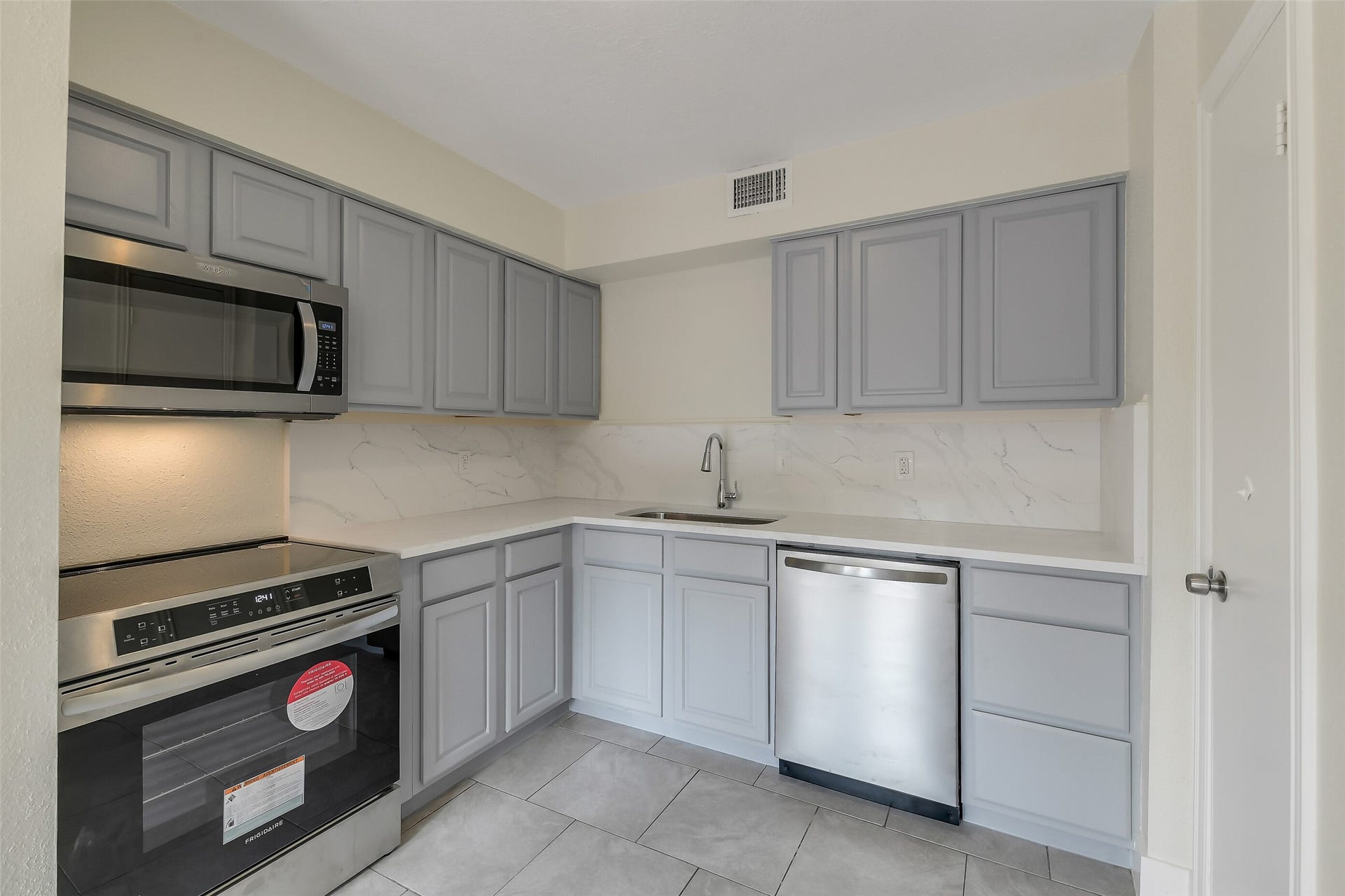Refreshed countertops & cabinetry and new stainless appliances give the kitchen a crisp modern look