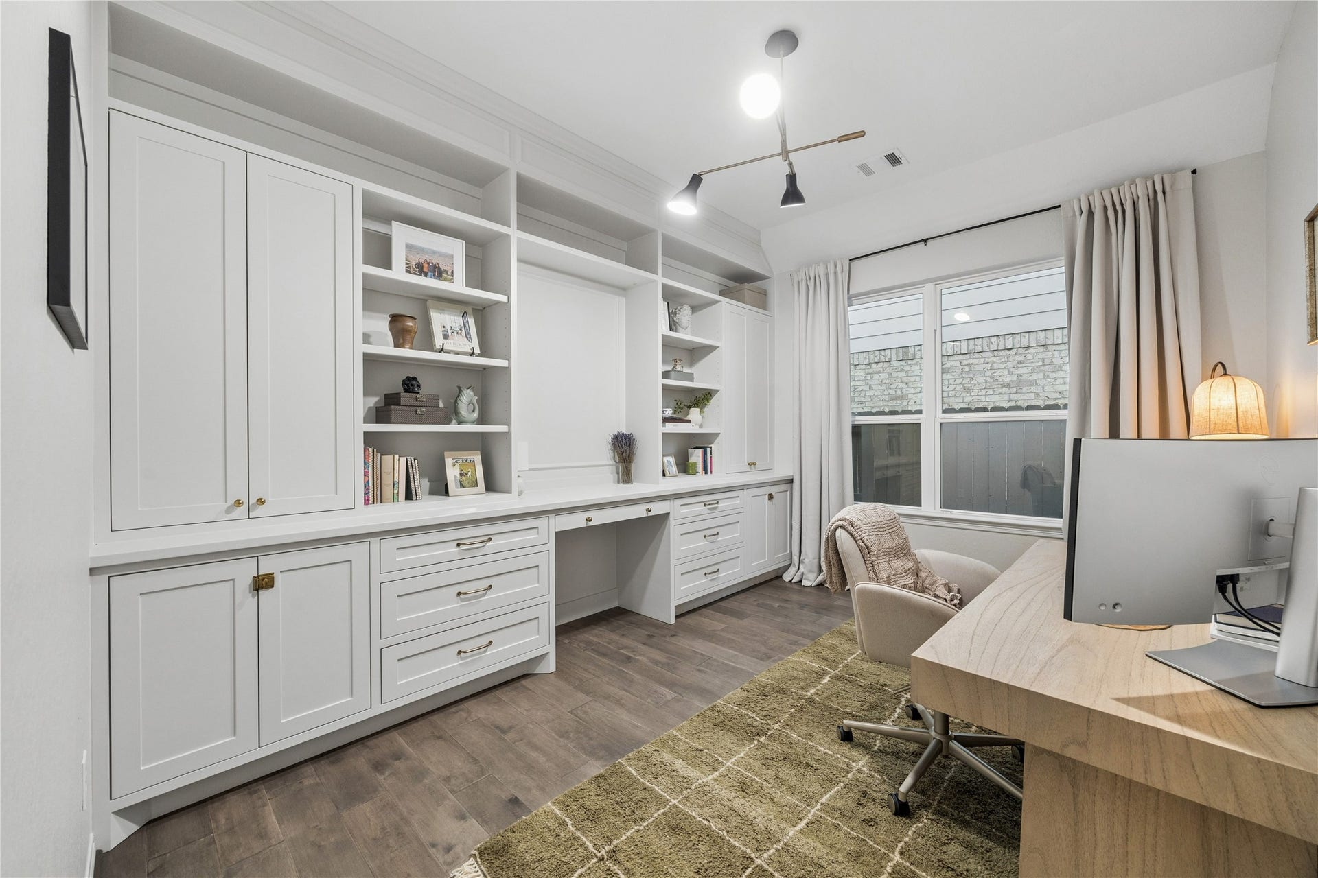 14231 Archer County Trail, Cypress, TX 77429 14x10 first floor office with custom site built cabinetry, desk, drawers & open shelves. updated designer LED lighting. window treatments.