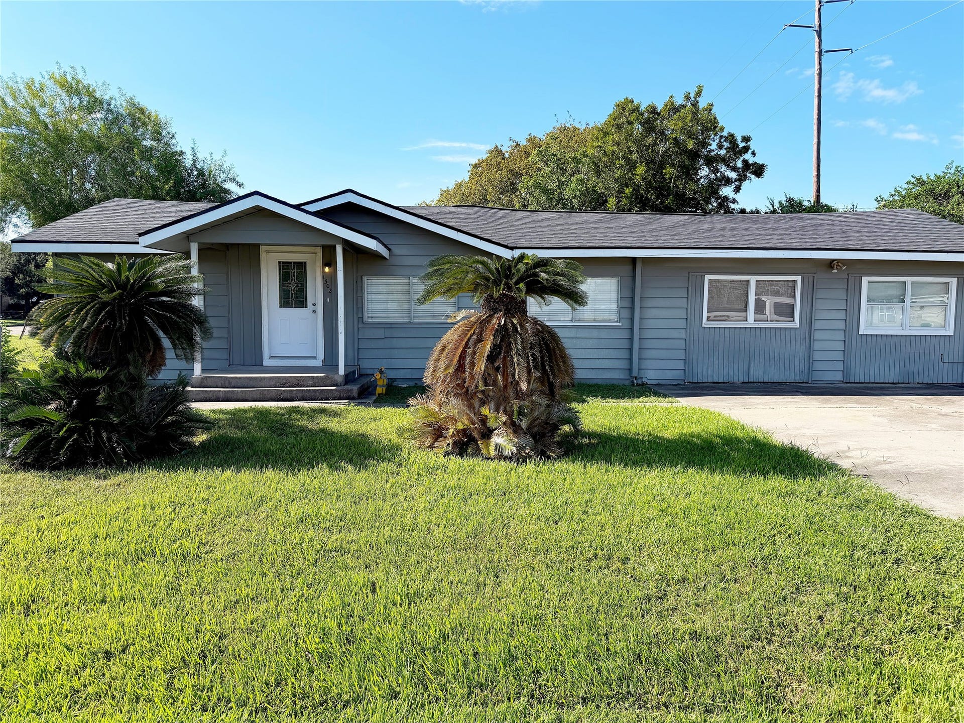 1302 N Avenue R, Freeport, TX 77541 Exterior front view features a small covered porch that creates a defined entry and provides a sheltered space at the front door.