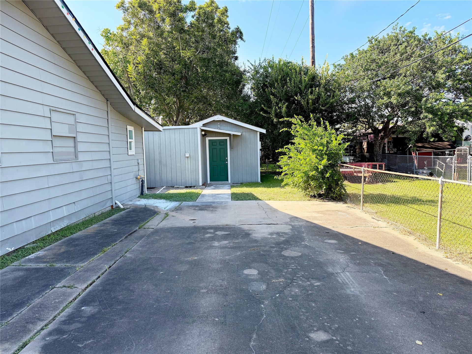 1302 N Avenue R, Freeport, TX 77541 Driveway provides convenient parking and access to the separate garage apartment located at the rear of the property.
