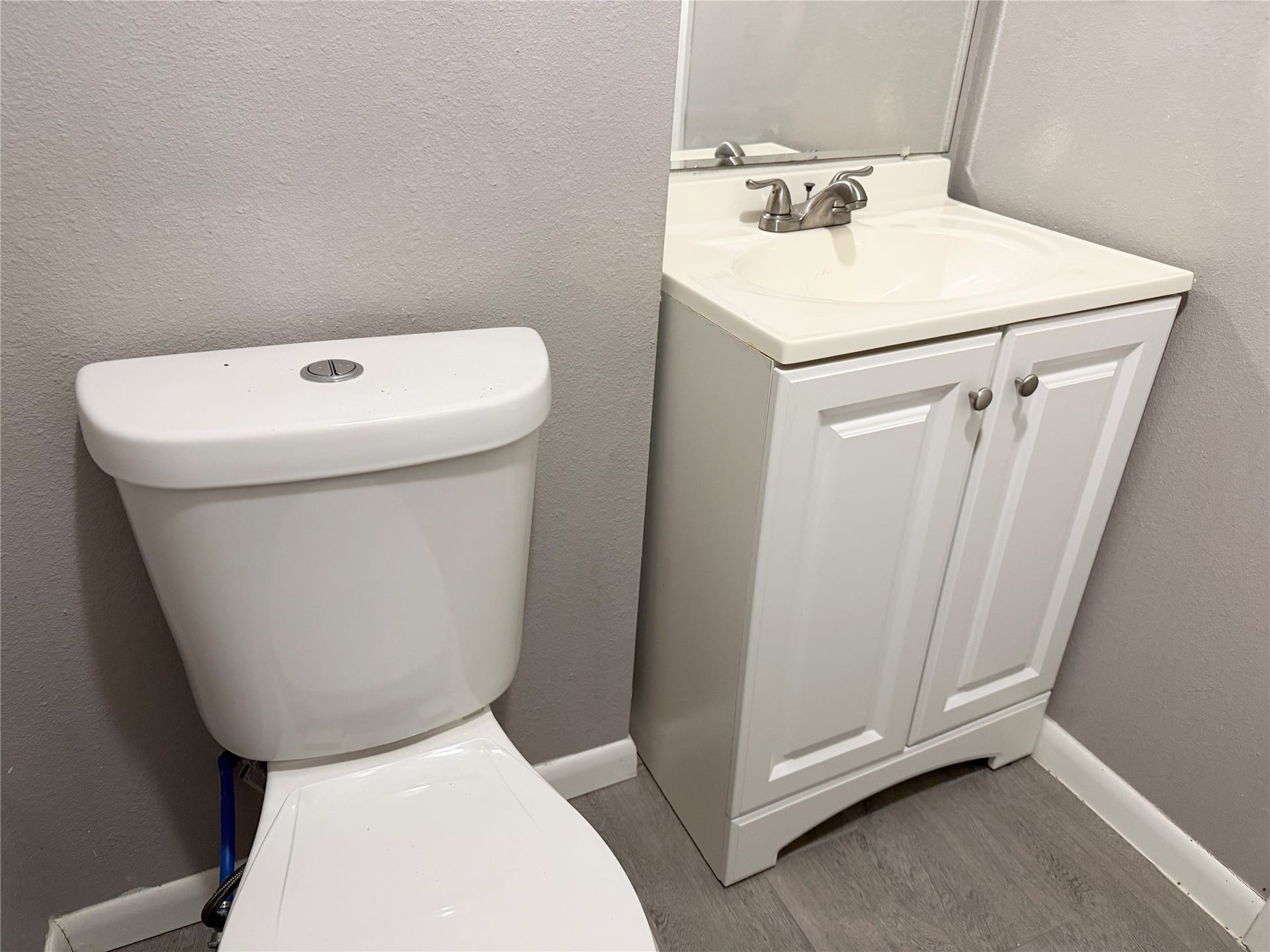 1302 N Avenue R, Freeport, TX 77541 Half bath is conveniently located just off the bedroom, providing added functionality and privacy.