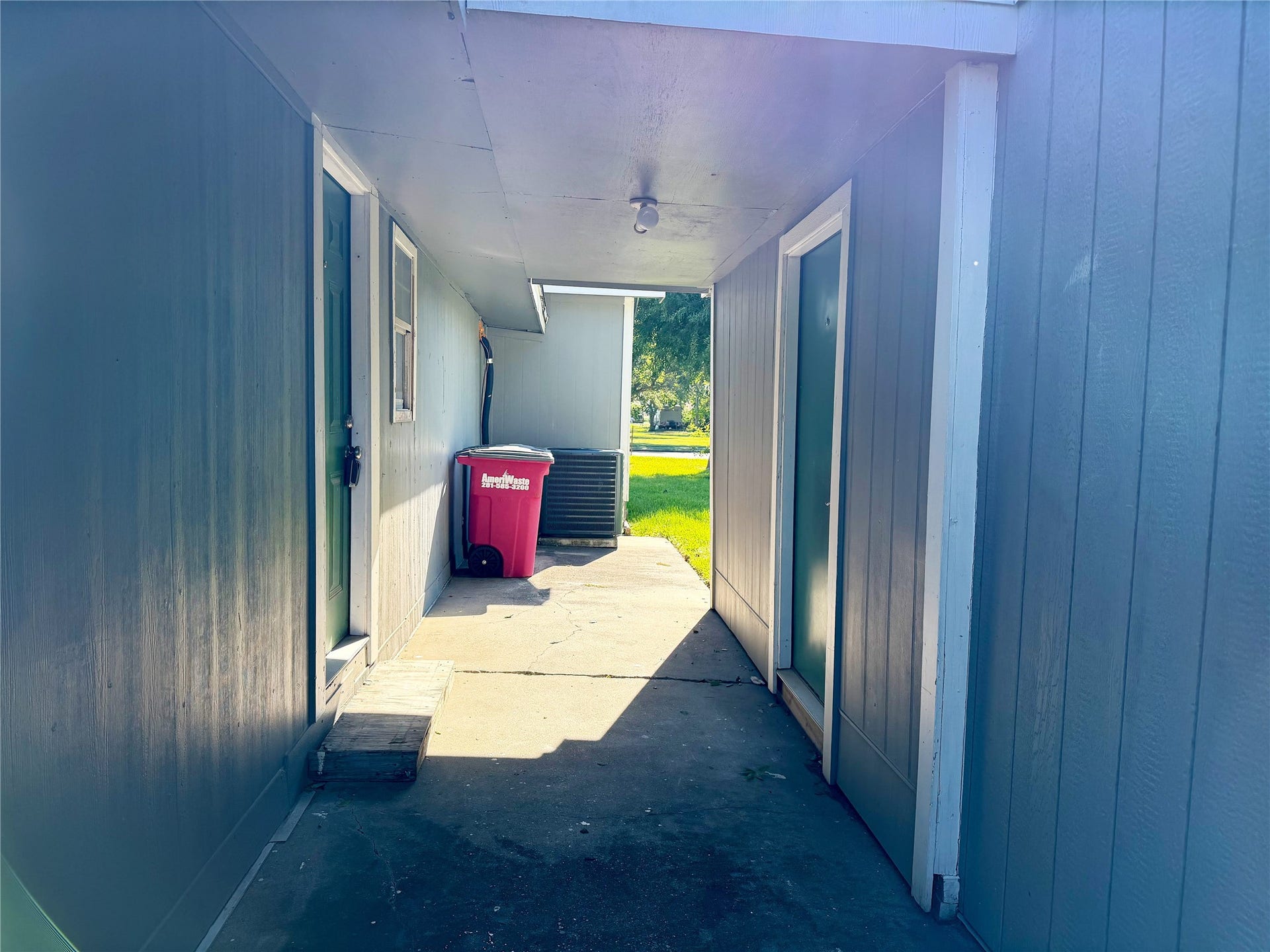 1302 N Avenue R, Freeport, TX 77541 Covered walkway connects the back door to the separate garage apartment, providing a sheltered path between the two spaces.