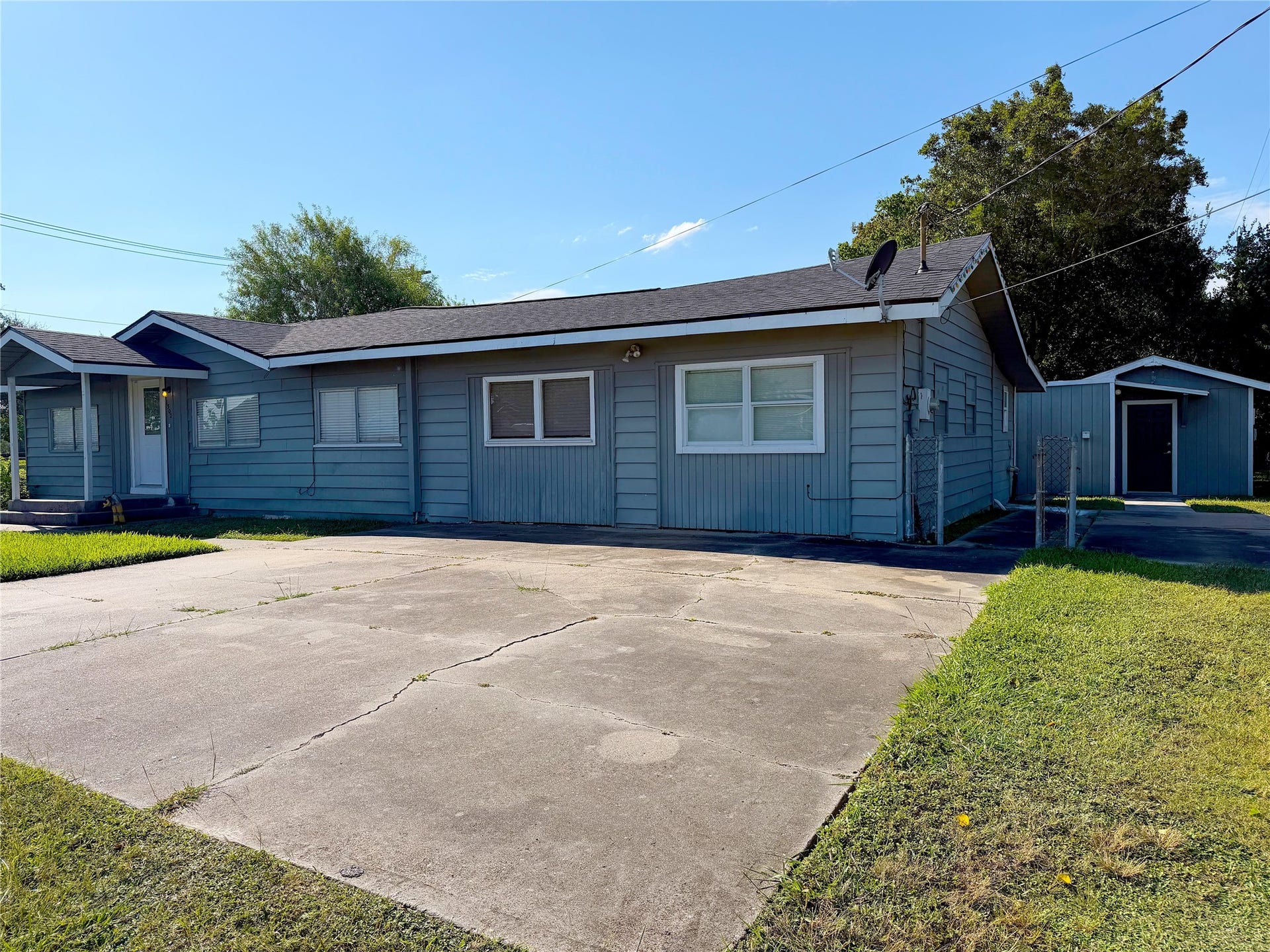 1302 N Avenue R, Freeport, TX 77541 The front exterior offers a covered entry porch that adds a practical transition from the walkway to the front door.