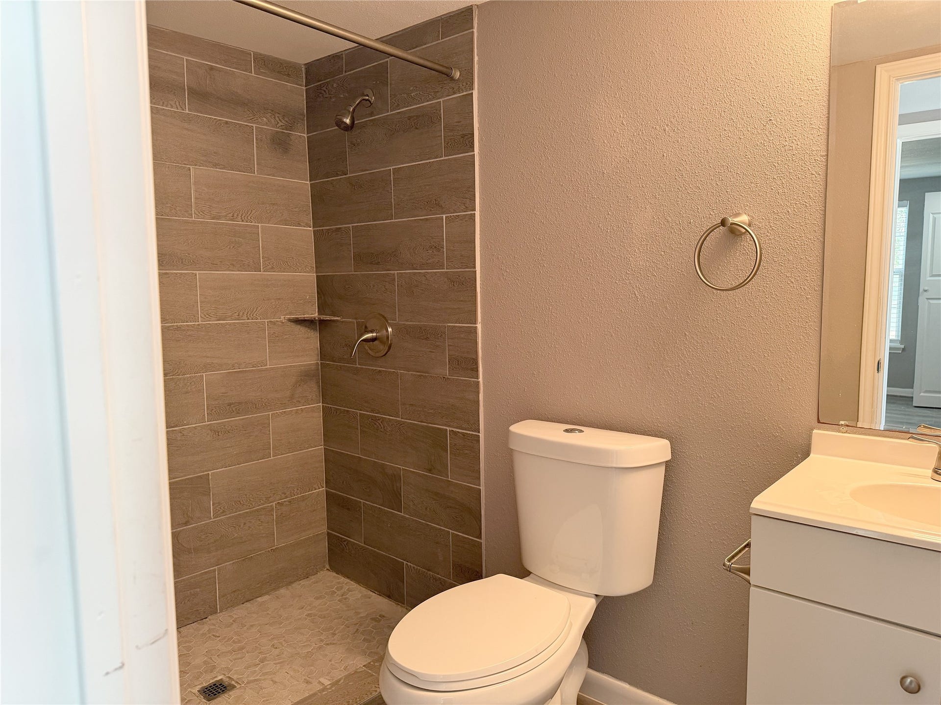 1302 N Avenue R, Freeport, TX 77541 Compact bathroom in the garage apartment offers the essential fixtures in a functional layout.