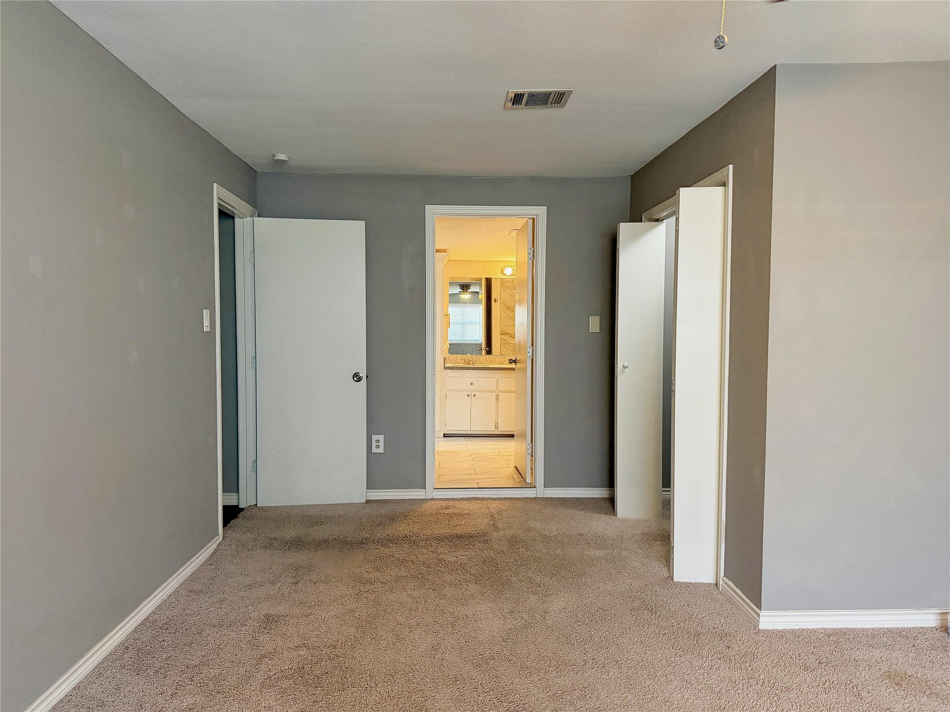 1302 N Avenue R, Freeport, TX 77541 Primary bedroom offers direct access to the full bathroom for added convenience and privacy.