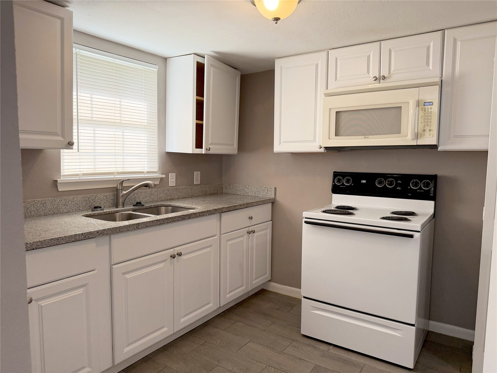 1302 N Avenue R, Freeport, TX 77541 Garage apartment features a functional kitchen and laundry area combined into one convenient space for everyday use.