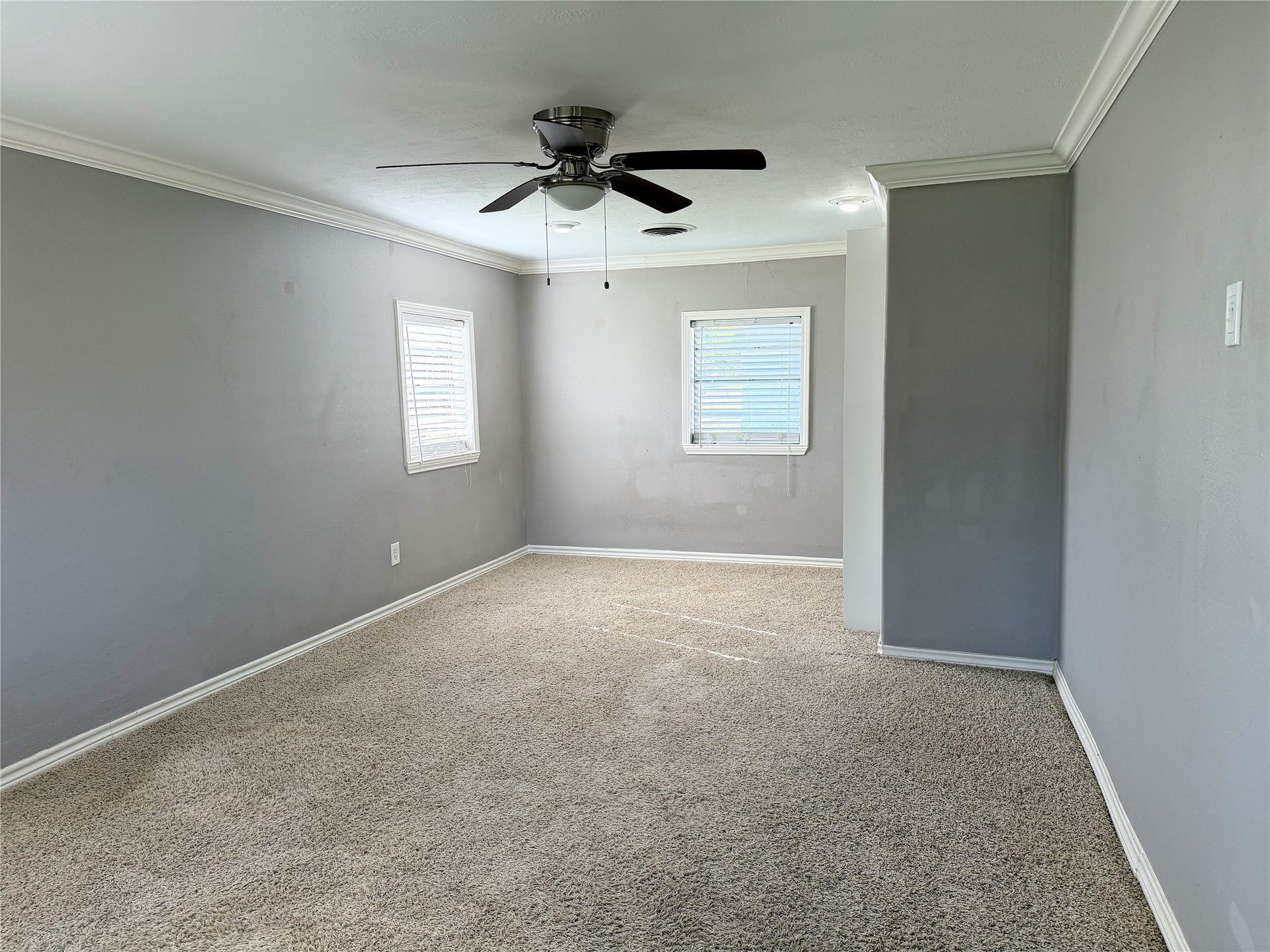 1302 N Avenue R, Freeport, TX 77541 Additional bedroom features carpeting and offers comfortable space with flexibility for a variety of uses.