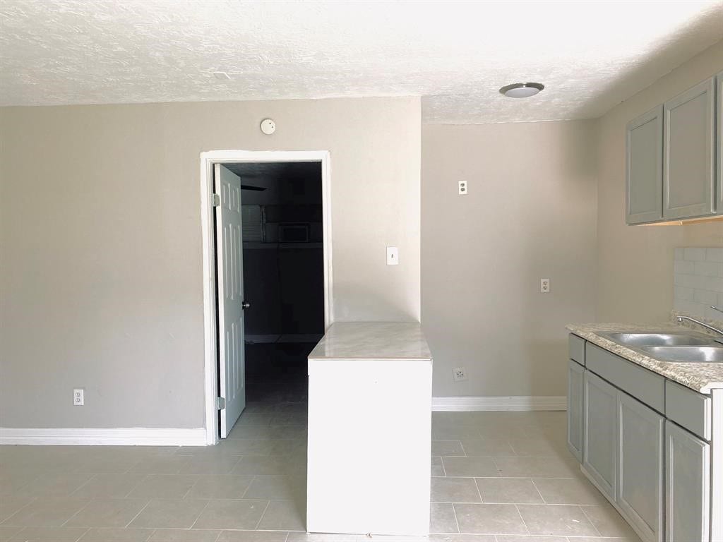 3406 Daphne St Street, #5, Houston, TX 77021 Bright kitchen featuring light gray cabinetry, modern countertops, and a convenient dual sink.