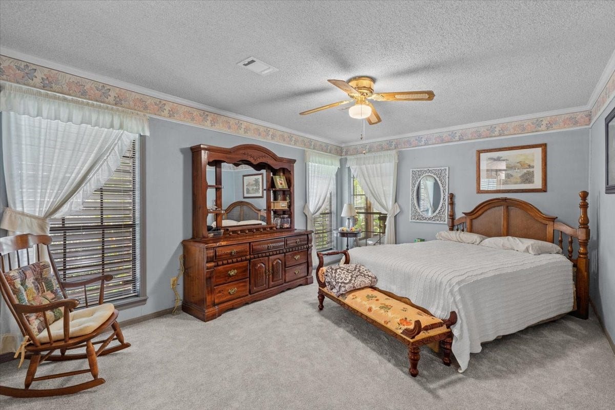 8717 Acorn Lane, Hitchcock, TX 77563 Primary bedroom with carpet floors and en suite bathroom.