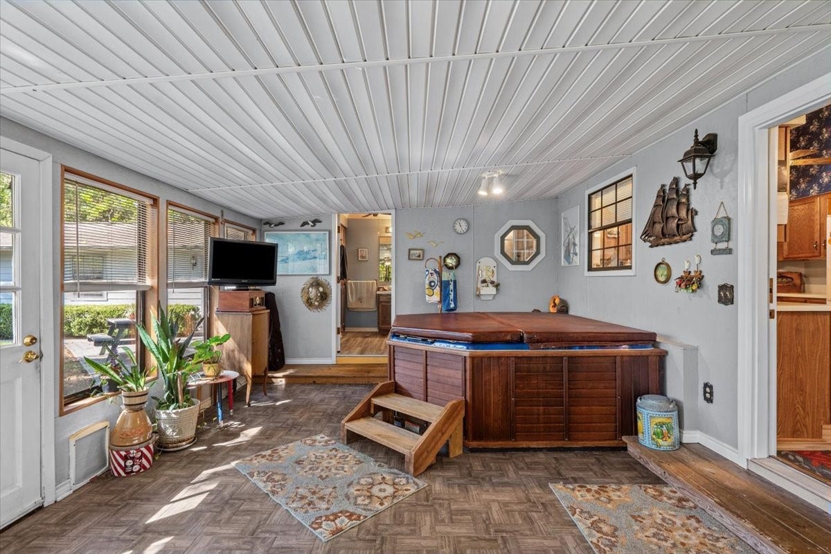 8717 Acorn Lane, Hitchcock, TX 77563 Screened in patio with hot tub and door to bathroom.