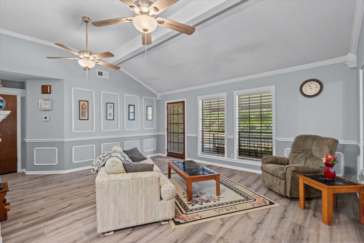 8717 Acorn Lane, Hitchcock, TX 77563 Living room with vinyl plank flooring.