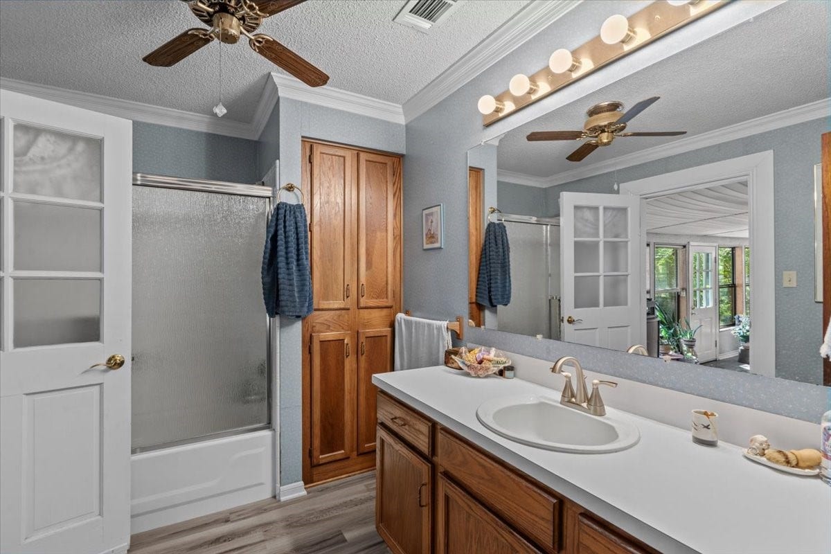 8717 Acorn Lane, Hitchcock, TX 77563 Secondary bedroom with tub/shower combo and door to screened in patio.