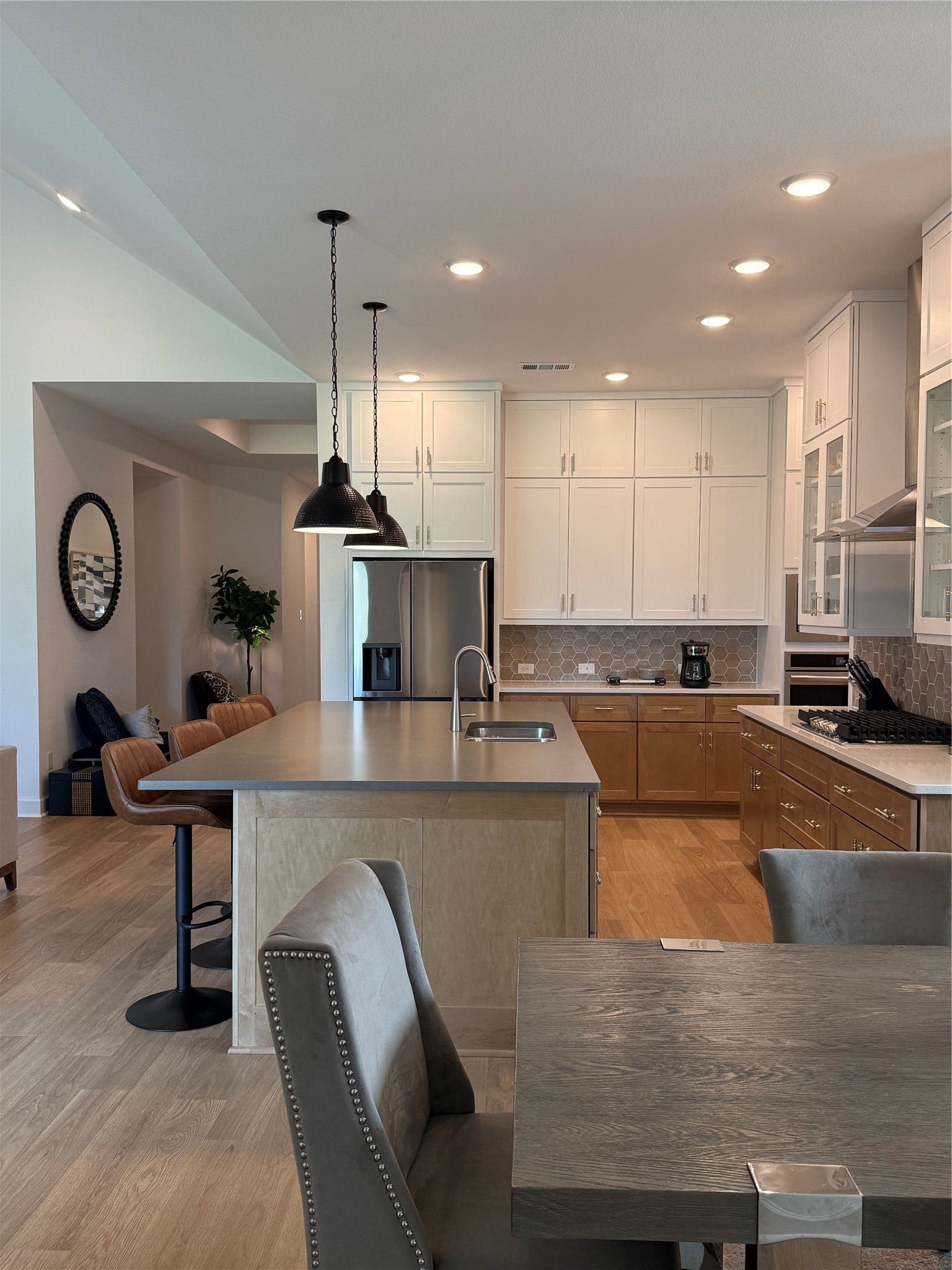 9911 Deep Water Drive, Missouri City, TX 77459 Modern kitchen with sleek cabinetry, a spacious island with bar seating, and smart pendant lighting.