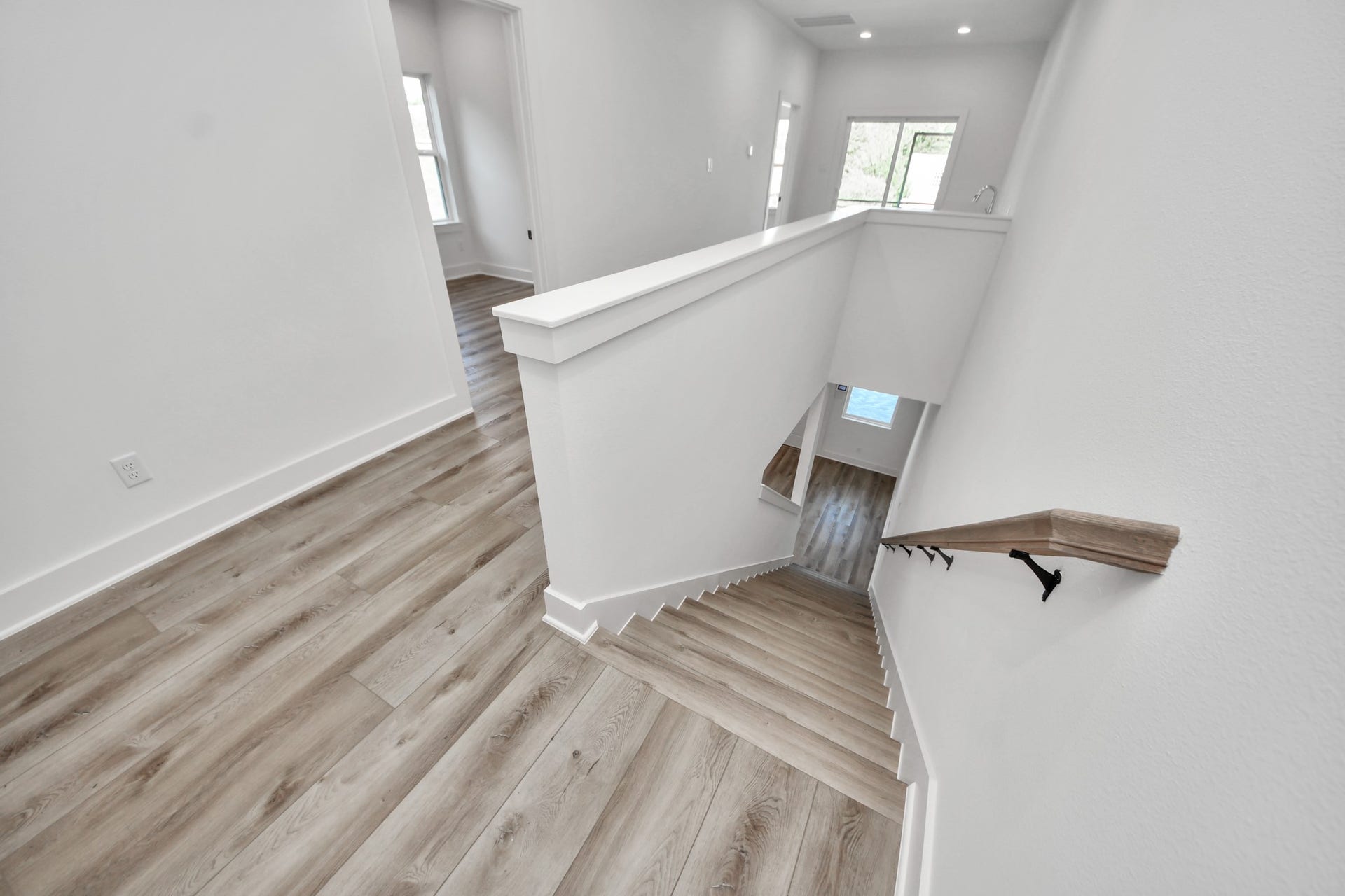2904 Ruth Street, Houston, TX 77004 Unit A upstairs landing with wood-look flooring and stairway access.