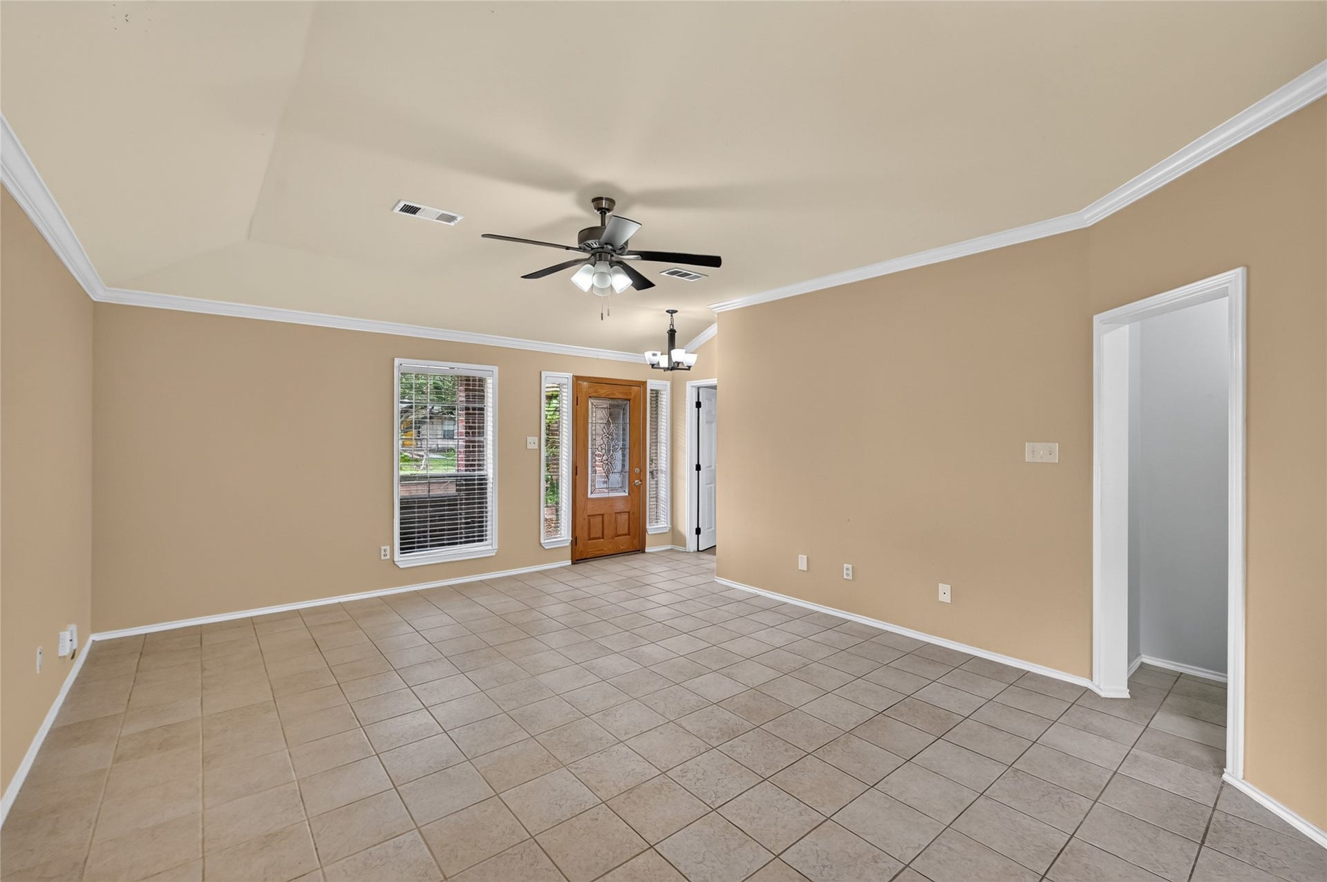 The front door opens to the living
room, secondary bedroom to the
left and hallway to the other two
bedrooms