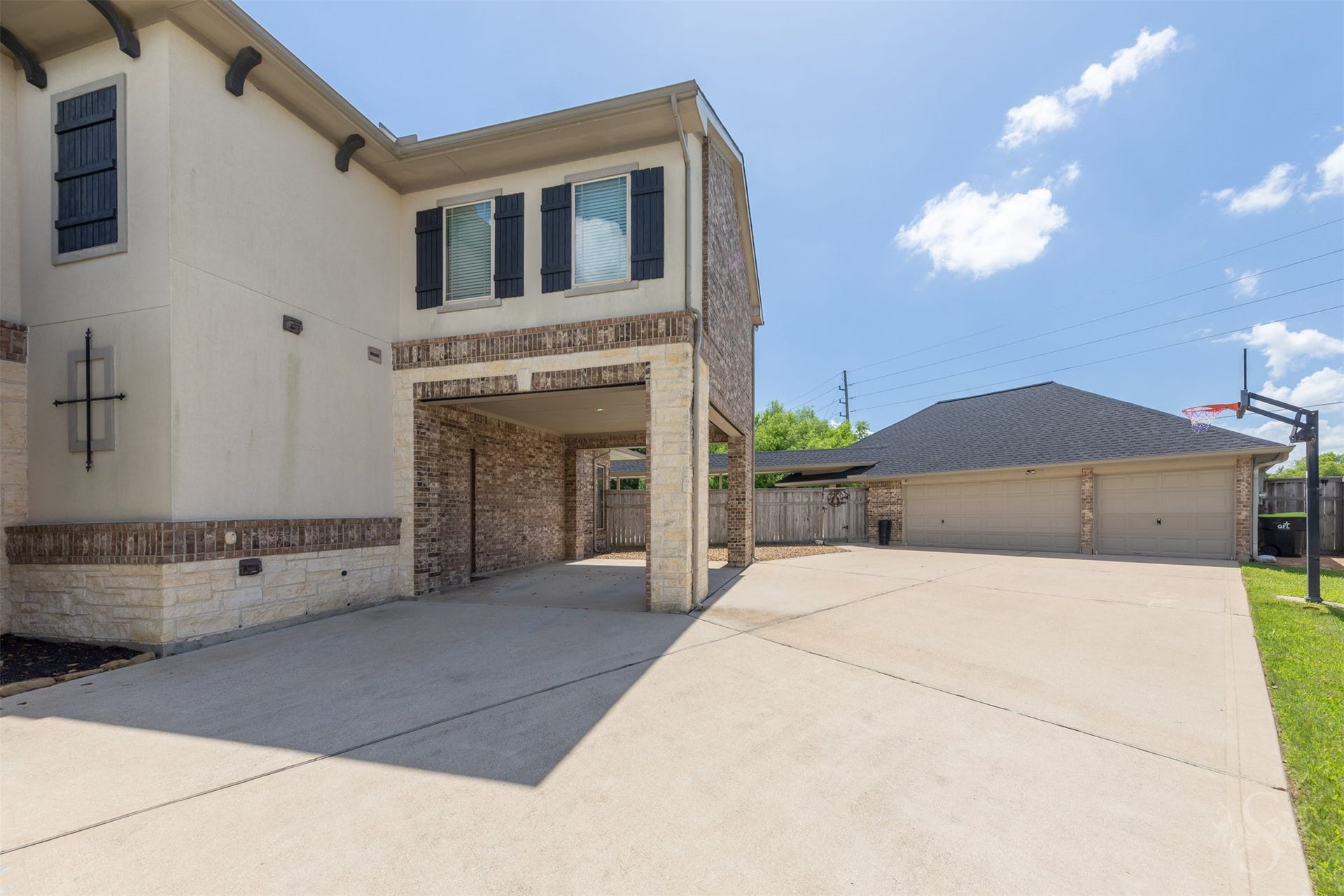 5835 Caspian Falls Lane, Fulshear, TX 77441 A covered porte-cochre adds architectural charm and convenient sheltered access to the home, while the expansive driveway leads to an impressive 6 car garage with plenty of room for vehicles, hobbies, or storage. Oversized floored attic storage above the garage and additional interior storage space provide exceptional organization options, and the generous driveway easily accommodates guests or recreational vehicles.