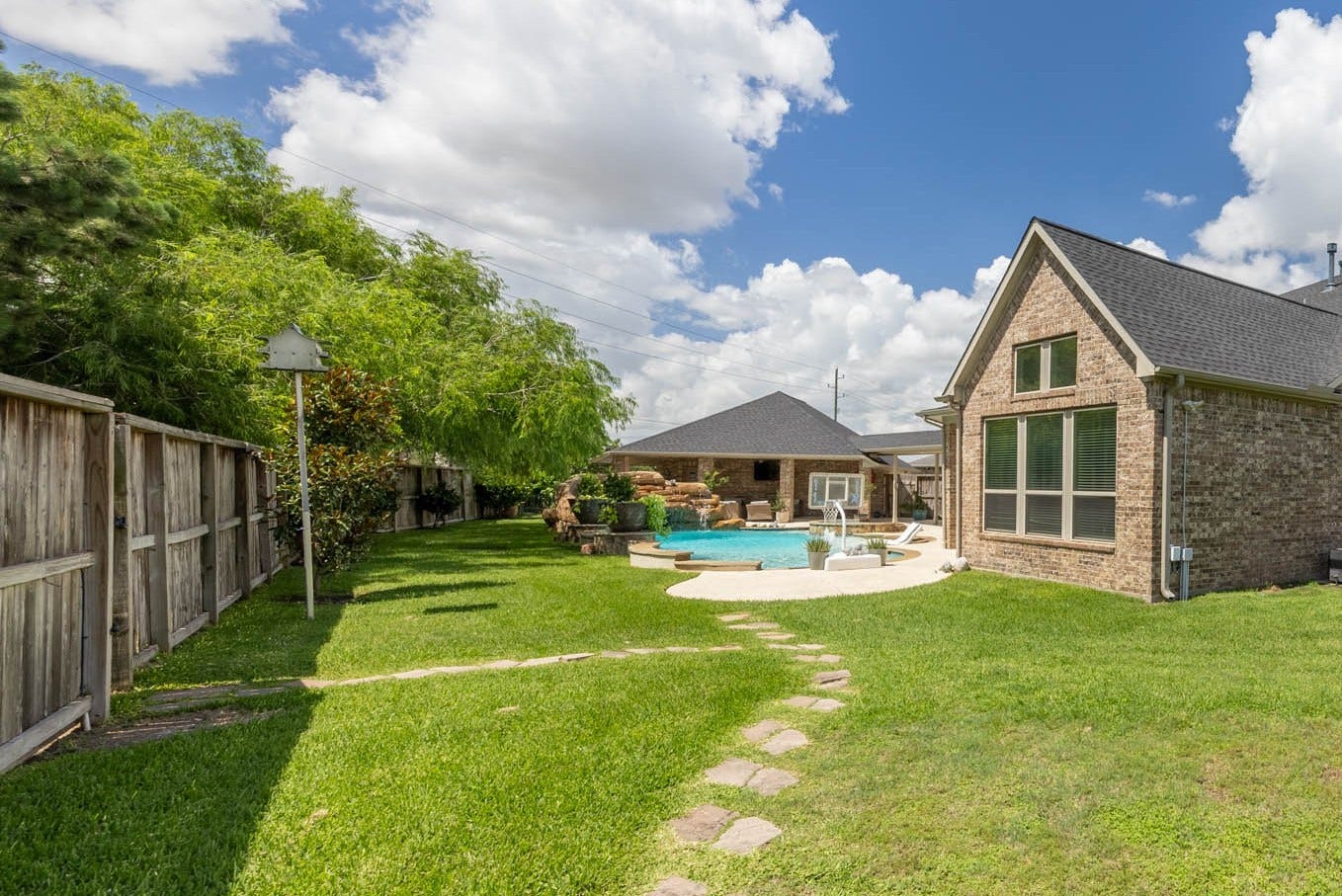 5835 Caspian Falls Lane, Fulshear, TX 77441 Beyond the pool, you'll find an impressive amount of green space on this oversized lot with plenty of room for play, pets and outdoor activities. Mature trees and lush landscaping create a beautiful backdrop for this exceptional backyard retreat.