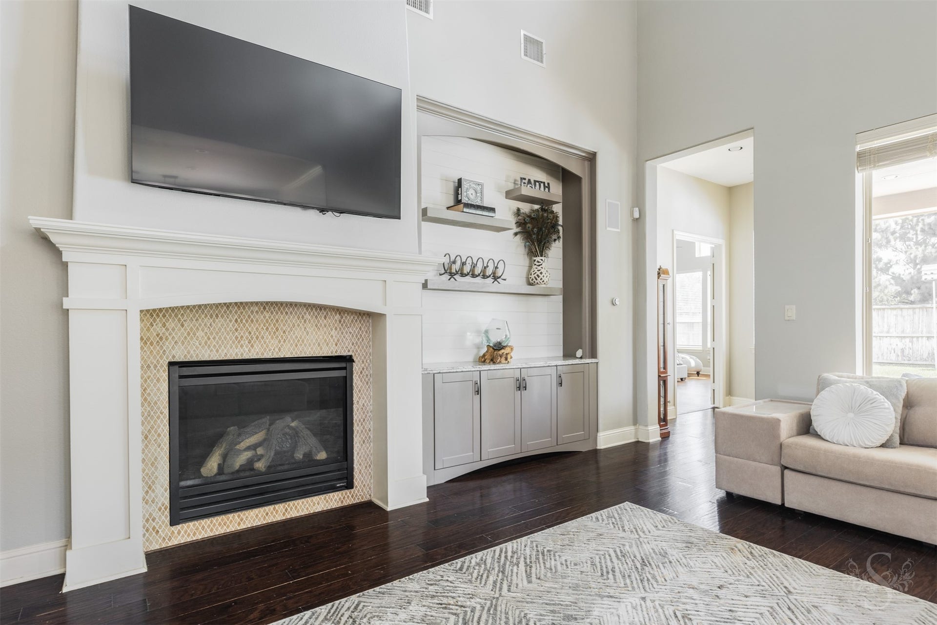 5835 Caspian Falls Lane, Fulshear, TX 77441 A beautiful fireplace and custom built-ins serves as the focal point of the impressive 2 story family room. Designed for gathering, this inviting space offers the perfect setting for relaxing evenings and memorable moments with family and friends.