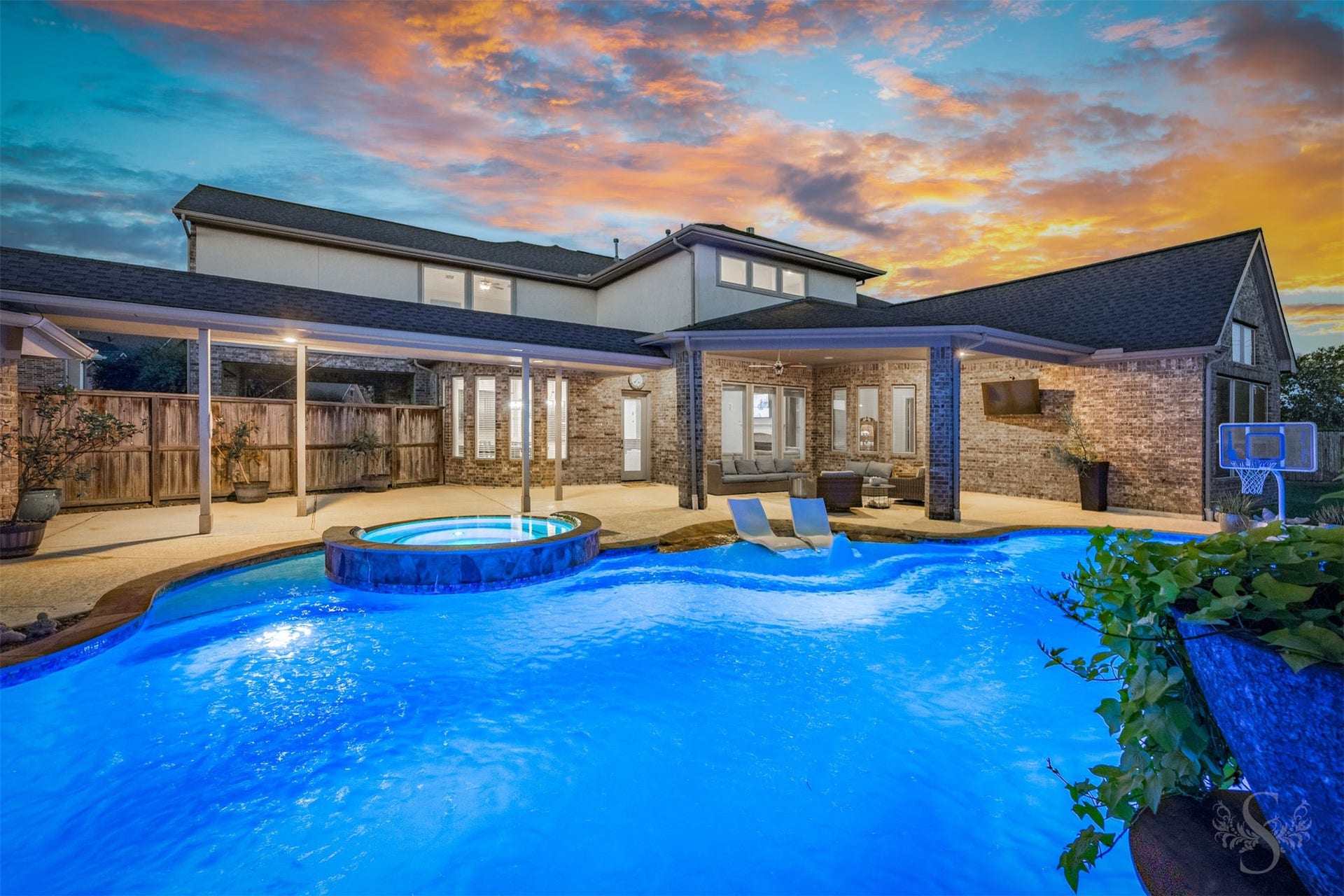 5835 Caspian Falls Lane, Fulshear, TX 77441 Resort-style living comes to life at sunset with this impressive custom pool and expansive outdoor living spaces. Two covered patios provide plenty of room for dining, lounging and hosting memorable gatherings.