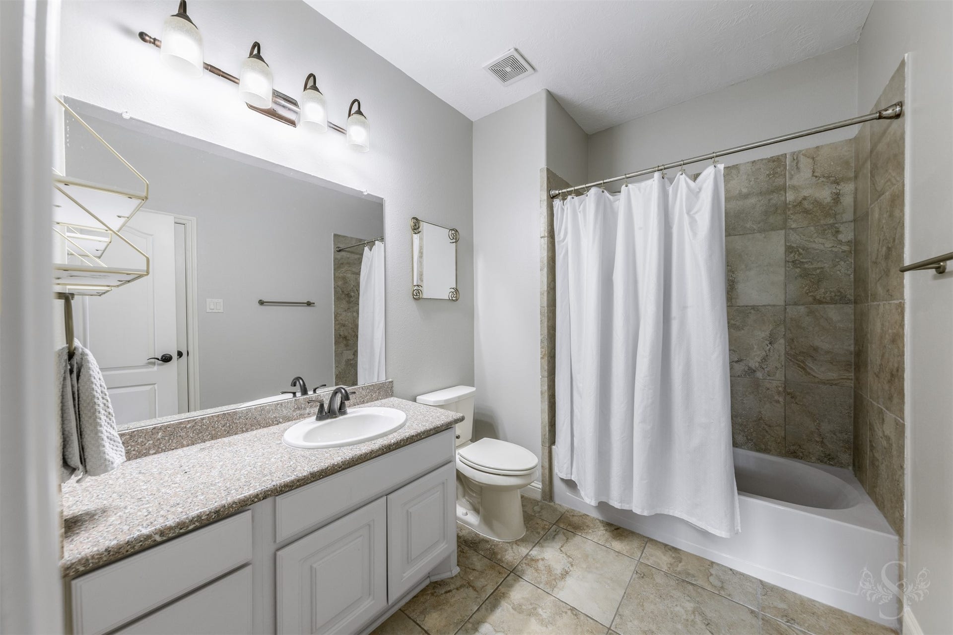 5835 Caspian Falls Lane, Fulshear, TX 77441 Granite countertops, tile flooring and a tub/shower combination make this secondary bath as practical as it is attractive. Neutral finishes provide a timeless look that complements the adjoining bedroom.