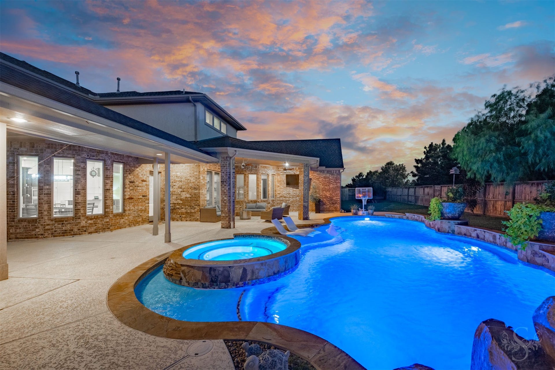 5835 Caspian Falls Lane, Fulshear, TX 77441 Your private backyard paradise awaits, featuring a spectacular custom Omega pool with spa, tranquil water features and stunning evening ambiance. With no back neighbors, you'll enjoy exceptional privacy while relaxing or entertaining outdoors.