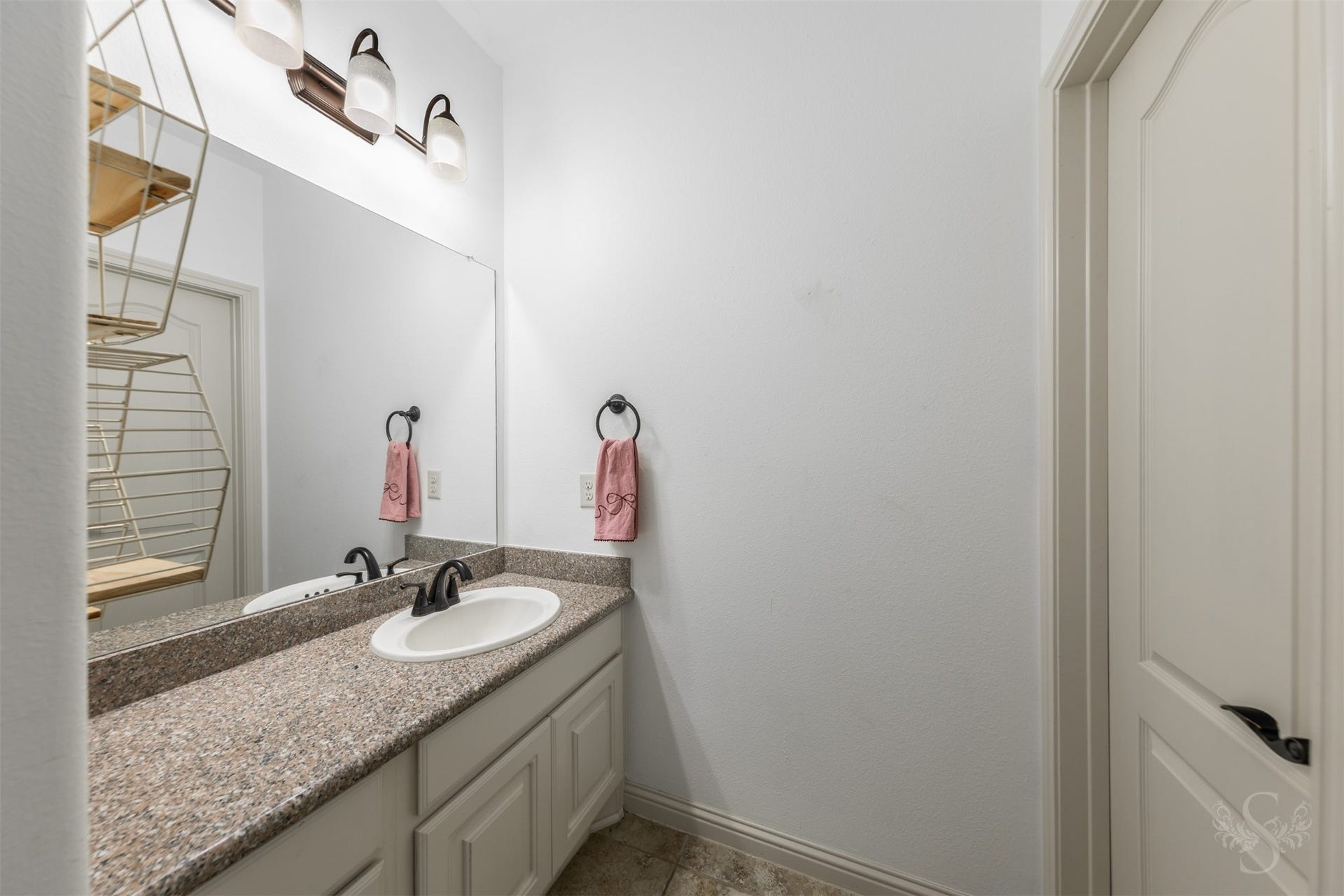 5835 Caspian Falls Lane, Fulshear, TX 77441 A private vanity area with granite counters and ample storage adds convenience and functionality to this well-designed secondary bath. The thoughtful layout allows multiple people to get ready with ease.