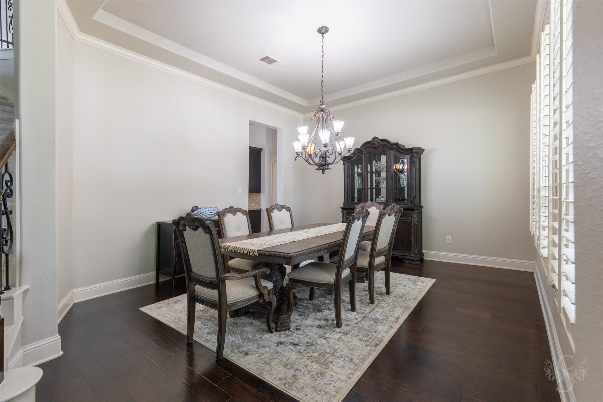 5835 Caspian Falls Lane, Fulshear, TX 77441 The elegant formal dining room is ready to host everything from intimate dinners to holiday celebrations. Plantation shutters, crown molding and a tray ceiling add architectural character, while the open layout allows for effortless entertaining.
