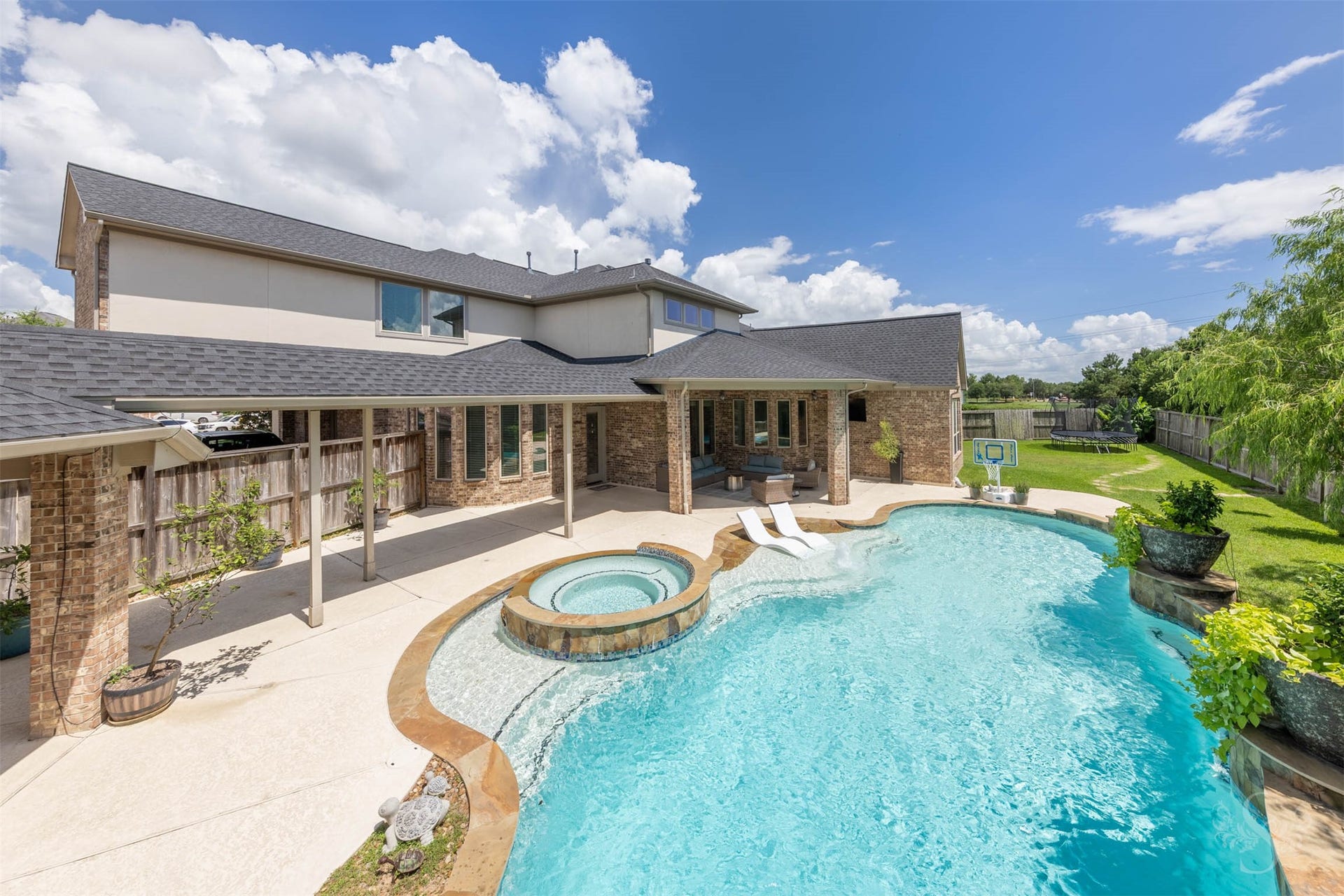 5835 Caspian Falls Lane, Fulshear, TX 77441 Step outside to your own private backyard retreat featuring a sparkling pool, elevated spa and expansive covered patio. Multiple outdoor living areas provide plenty of space for relaxing, dining and entertaining year-round.