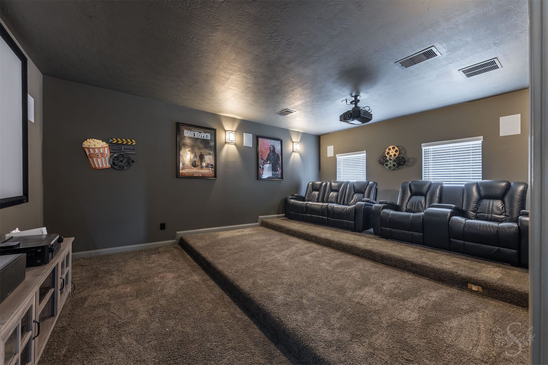 5835 Caspian Falls Lane, Fulshear, TX 77441 Enjoy the ultimate movie-night experience in the dedicated media room featuring tiered seating and projector setup. Whether hosting a big game or family movie marathon, this space was designed for unforgettable entertainment.