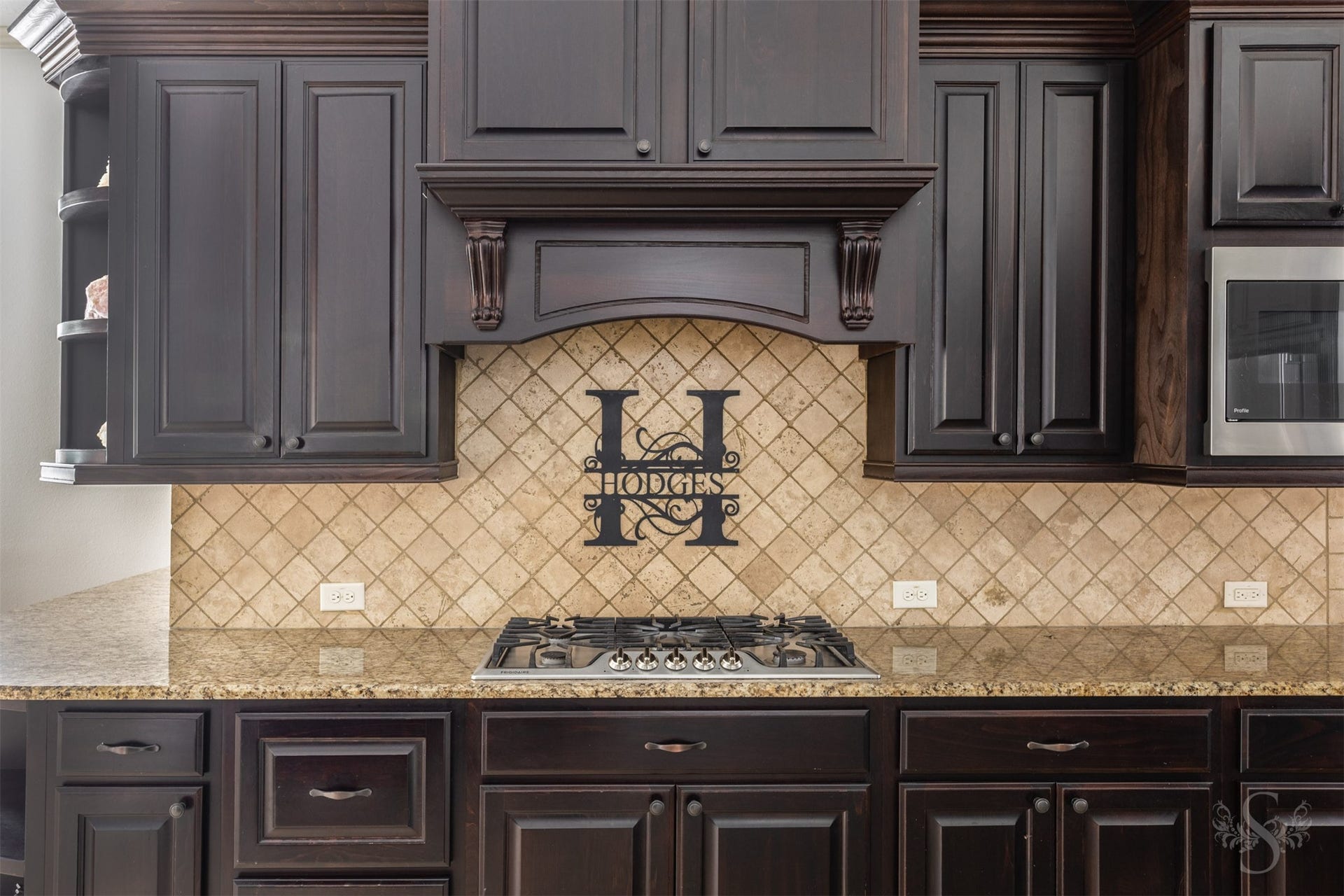 5835 Caspian Falls Lane, Fulshear, TX 77441 Custom cabinetry, decorative architectural details and a beautiful tile backsplash add character and charm to this well-appointed kitchen. Every element was carefully selected to create a space that is both elegant and functional.