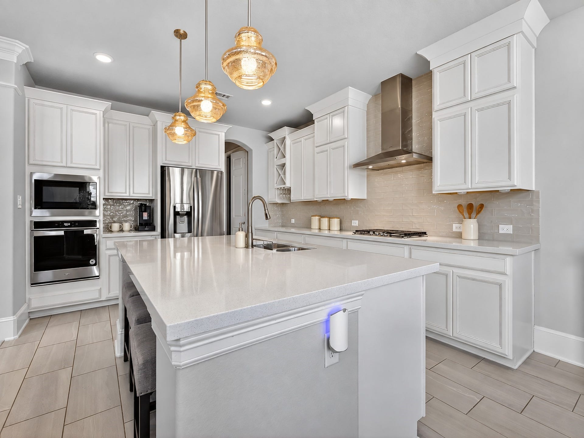 6714 Wellbrook Falls Lane, Katy, TX 77493 Spacious kitchen offers white cabinetry, built-in appliances, and generous island workspace. (virtually staged)