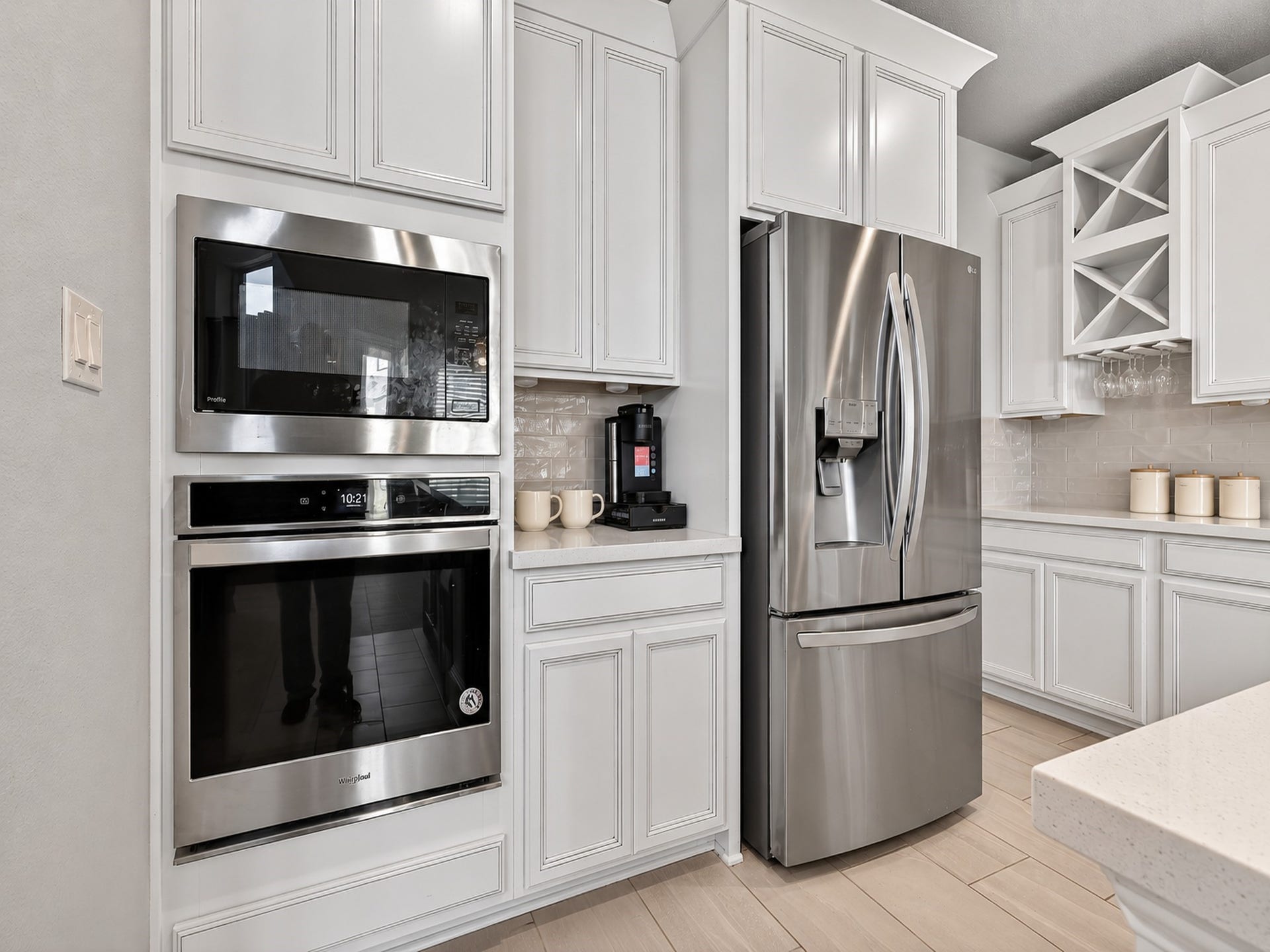6714 Wellbrook Falls Lane, Katy, TX 77493 Built-in microwave and oven complement white cabinetry and stainless appliances. (virtually staged)