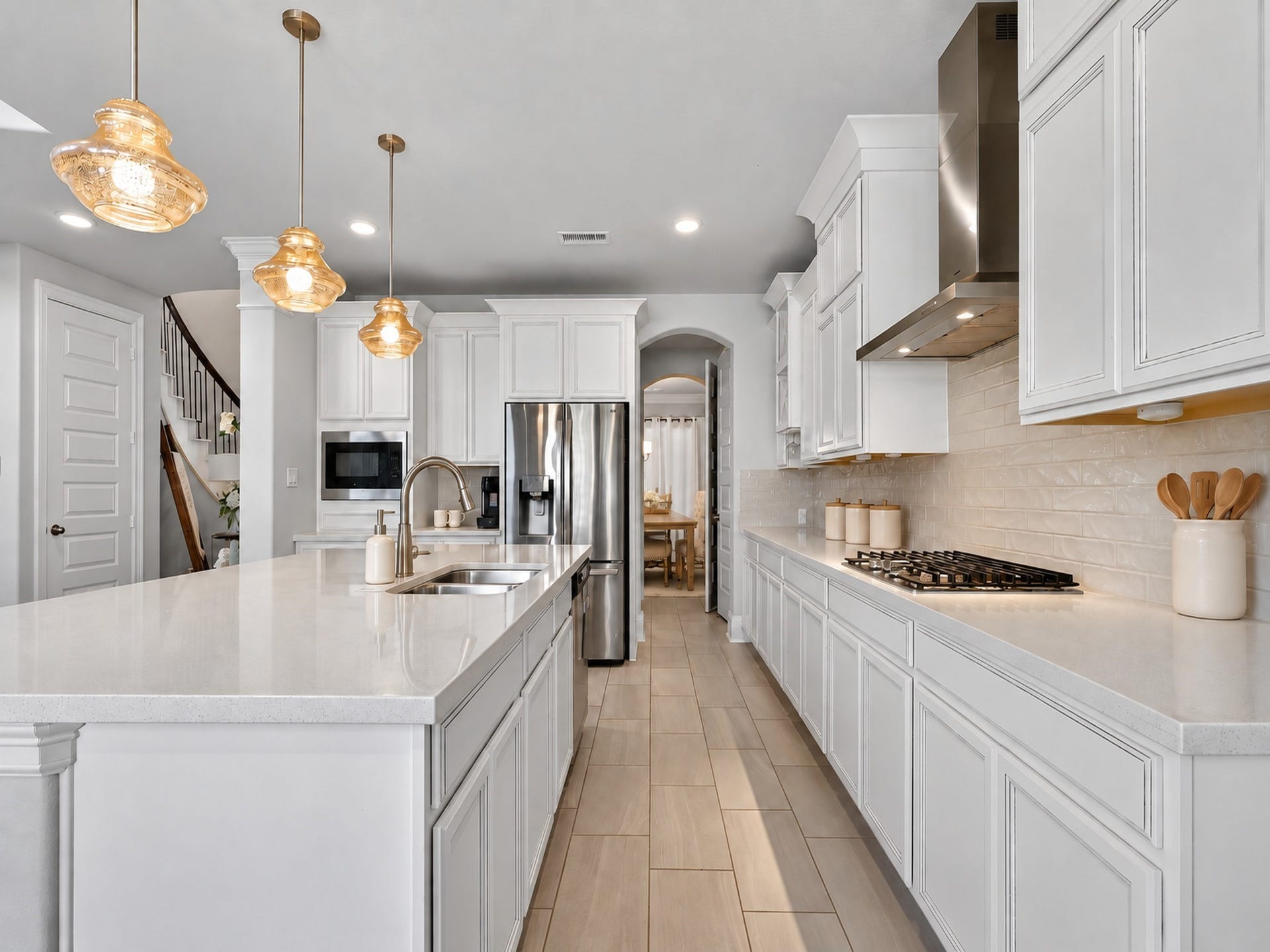 6714 Wellbrook Falls Lane, Katy, TX 77493 Kitchen features an island sink, gas cooktop, and ample counter space. (virtually staged)