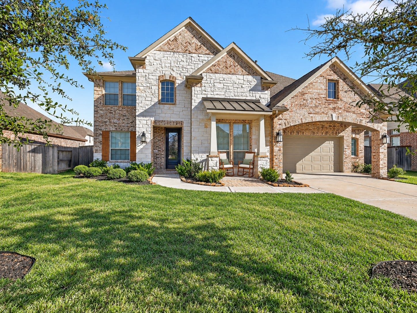 6714 Wellbrook Falls Lane, Katy, TX 77493 Welcoming brick exterior with a covered front porch and attached garage. (virtually staged)