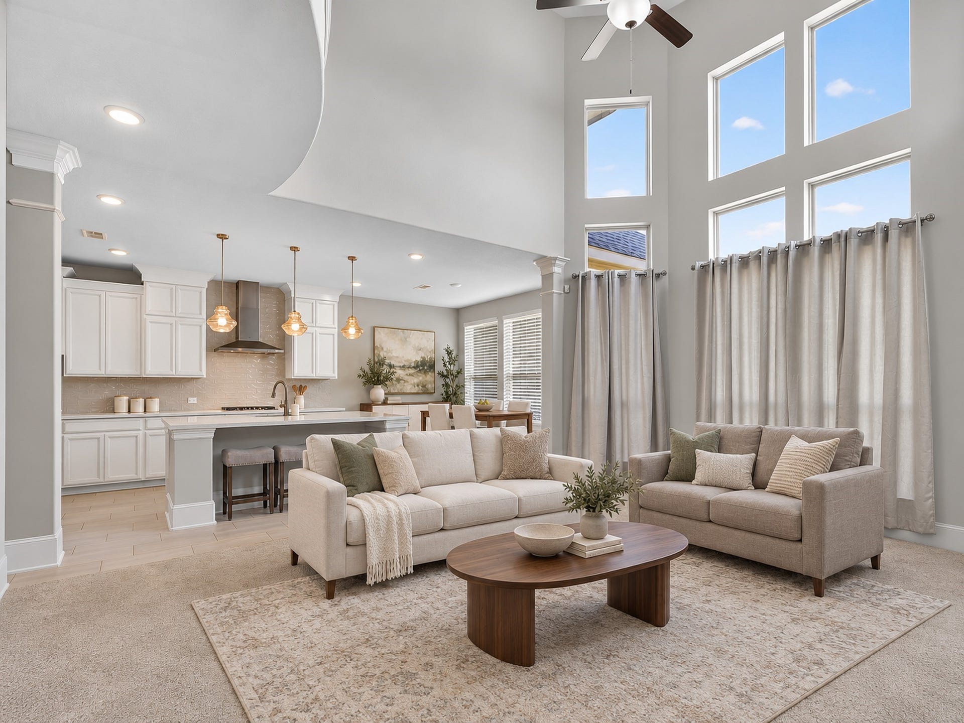 6714 Wellbrook Falls Lane, Katy, TX 77493 Two-story living room features expansive windows and an open connection to the kitchen. (virtually staged)