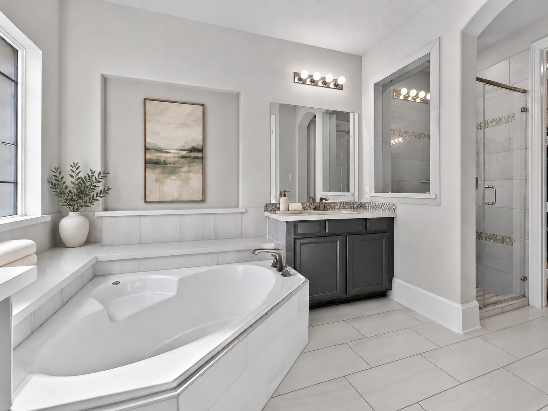 6714 Wellbrook Falls Lane, Katy, TX 77493 Primary bath features a soaking tub, separate glass-enclosed shower, and tile flooring. (virtually staged)