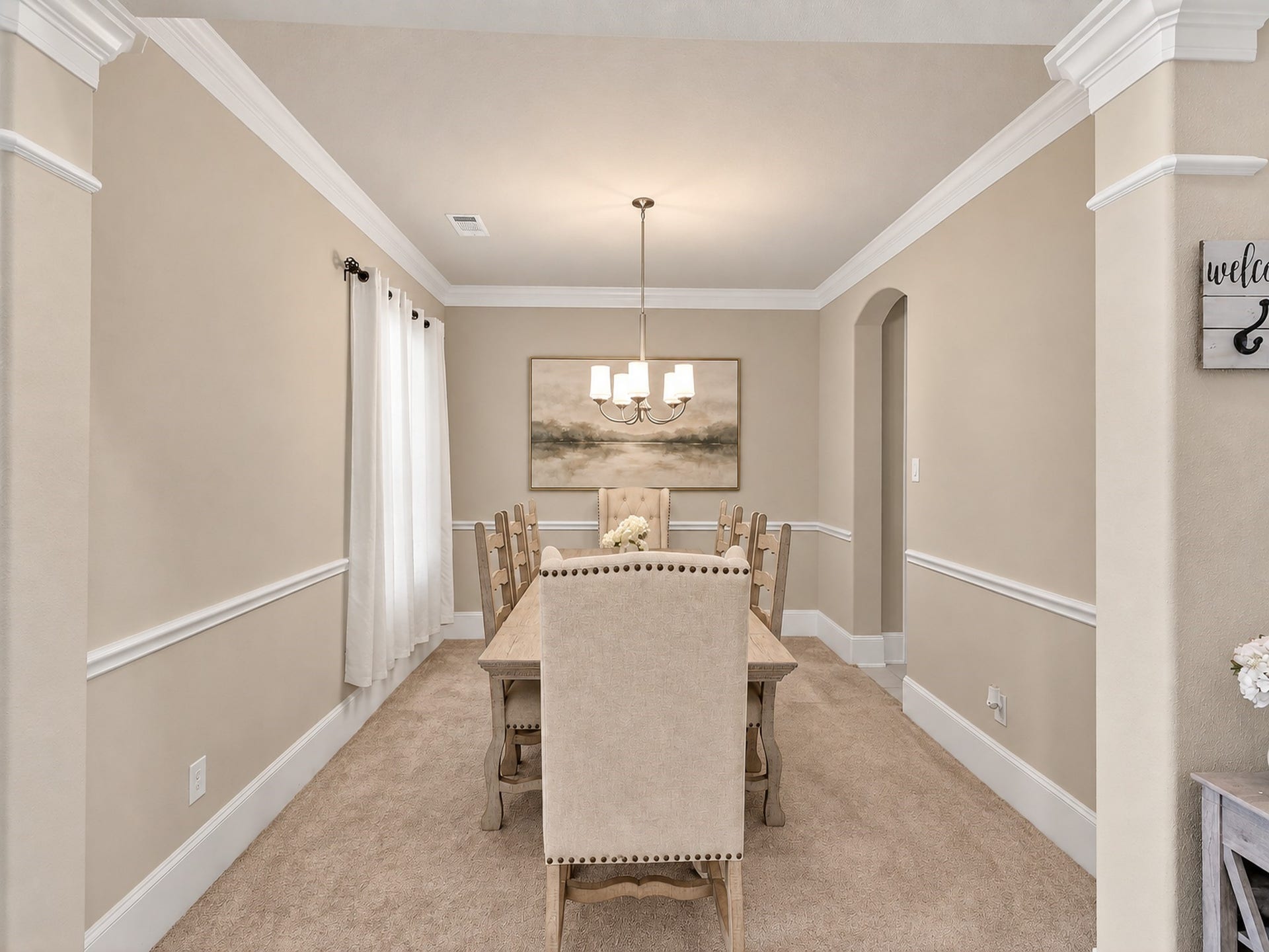 6714 Wellbrook Falls Lane, Katy, TX 77493 Formal dining room offers crown molding, chair rail, and wide entry openings. (virtually staged)