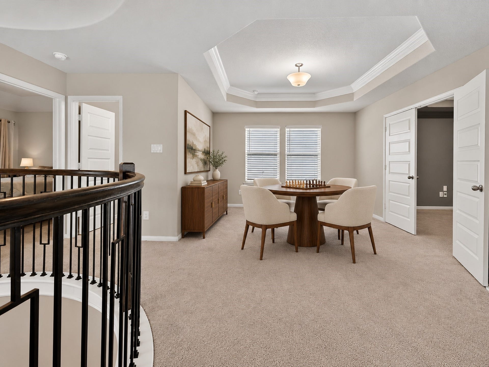 6714 Wellbrook Falls Lane, Katy, TX 77493 Upstairs flex space features a tray ceiling, natural light, and an open stairway railing. (virtually staged)