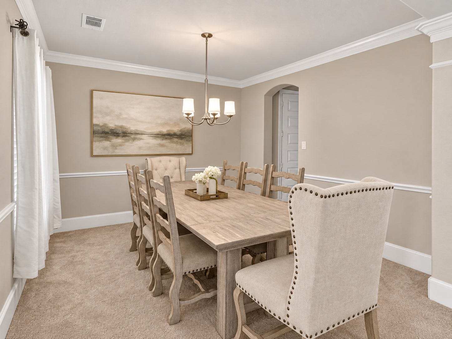 6714 Wellbrook Falls Lane, Katy, TX 77493 Formal dining room features crown molding, chair rail, and chandelier lighting. (virtually staged)