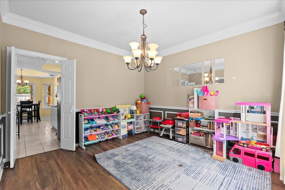 1908 Summer Reef Drive, League City, TX 77573 Walk your way from the kitchen to the formal dining room currently used as a kids playroom.