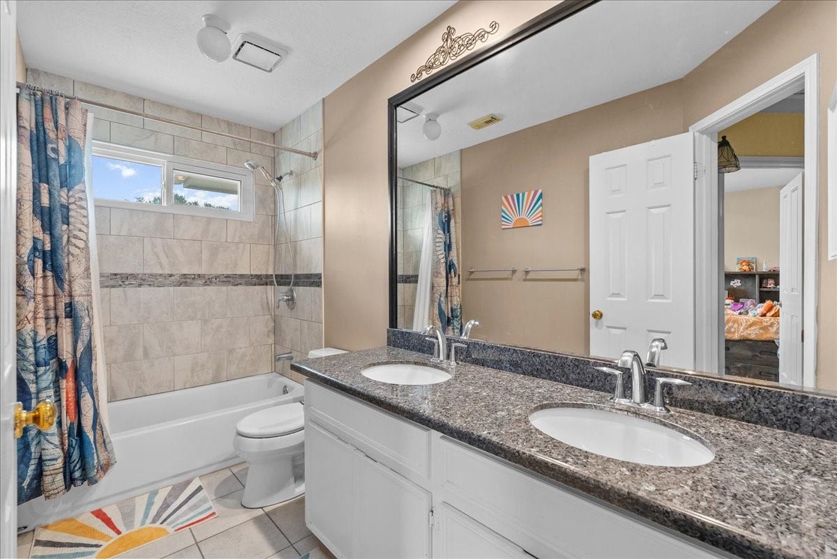 1908 Summer Reef Drive, League City, TX 77573 Dual sinks, granite counter-tops and framed mirror complete the secondary bathroom.