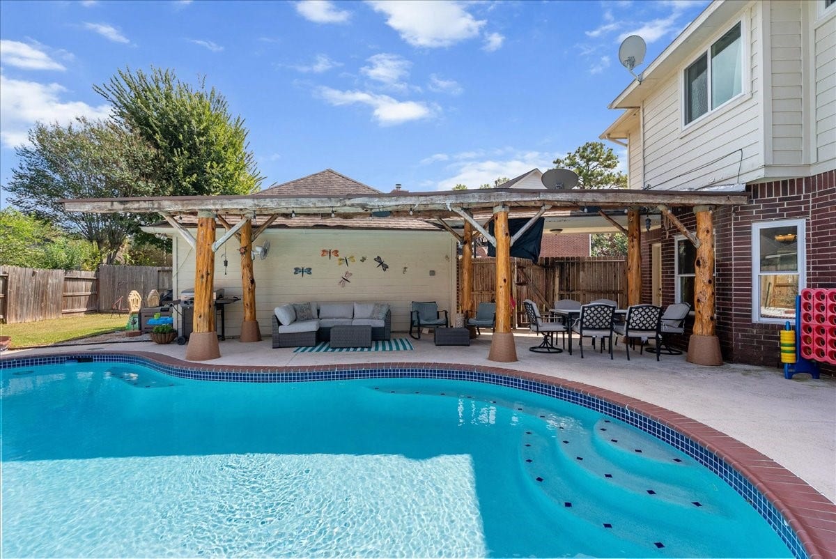 1908 Summer Reef Drive, League City, TX 77573 Check out that sparkling pool and oversized palapa.