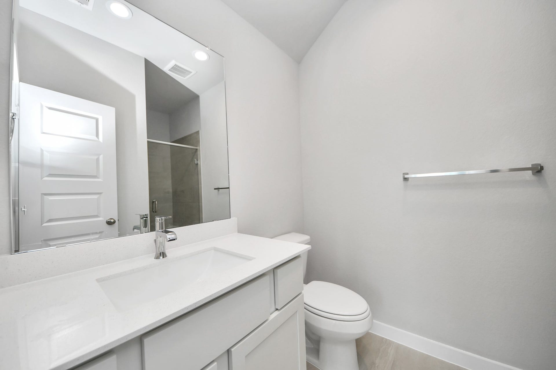11023 Hosta Stream Drive, Houston, TX 77044 Secondary bath features tile flooring, a walk-in shower with tile surround, light stained wood cabinets, beautiful light countertop. Sample photo of completed home with similar floor plan. Actual colors and selections may vary.
