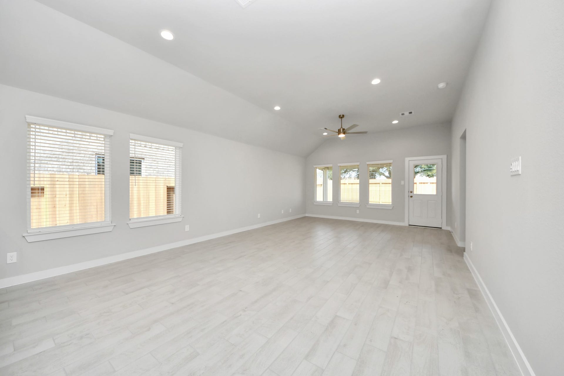 11023 Hosta Stream Drive, Houston, TX 77044 Relax and unwind in this inviting family room, illuminated by abundant natural light streaming in through tall windows, complemented by high ceilings and stunning flooring. Stay comfortable year-round with the gentle breeze from the ceiling fan, creating the perfect atmosphere for family gatherings. Sample photo of completed home with similar floor plan. Actual colors and selections may vary.