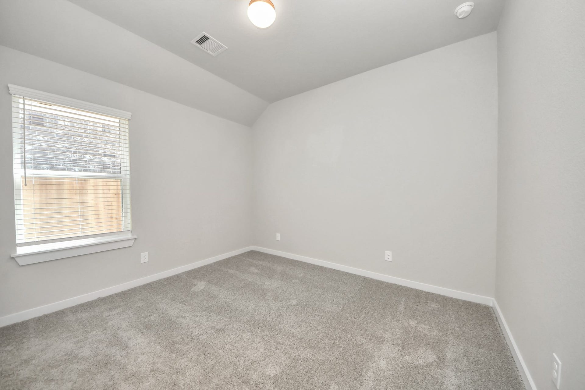 11023 Hosta Stream Drive, Houston, TX 77044 Secondary bedroom features plush carpeting, large windows that let in plenty of natural light, bright paint, and spacious closets. Sample photo of completed home with similar floor plan. Actual colors and selections may vary.